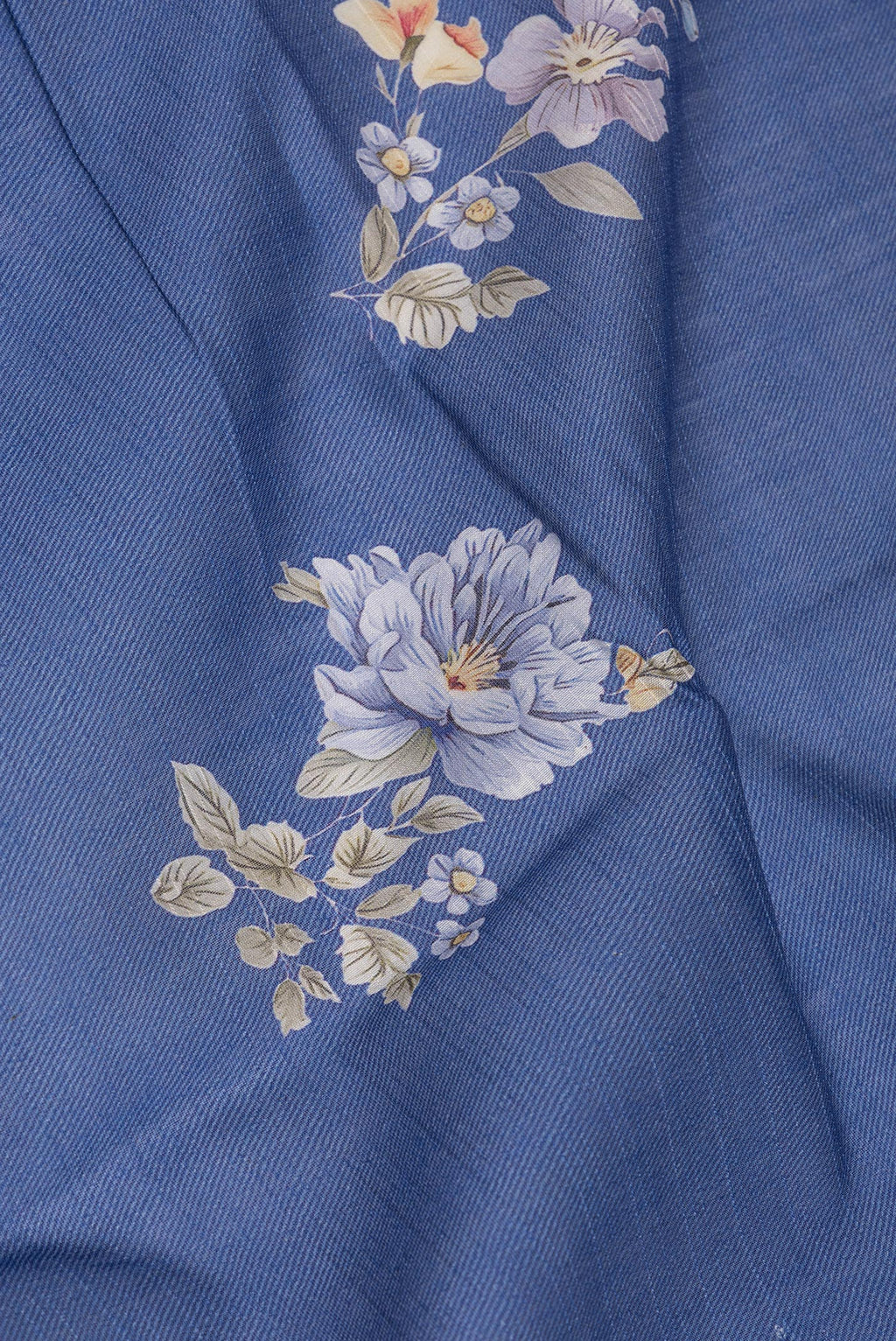 Close up of Pure Silk Navy Blue Dual Tone Chanderi Saree with Printed design on the body and Zari And Thread Border.  displaying folds