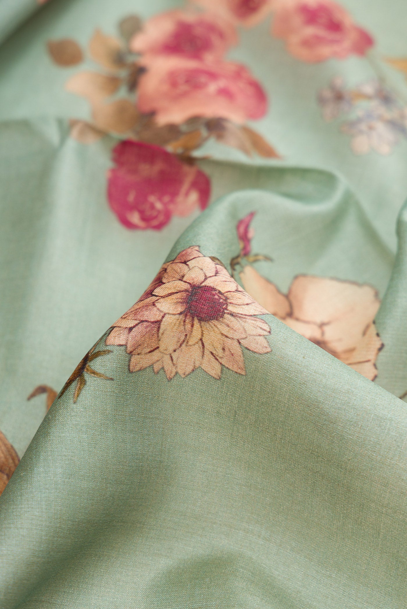 Close up of Sea Green Dual Tone Tussar Silk Saree with Printed design on the body and Zari Border.  displaying folds