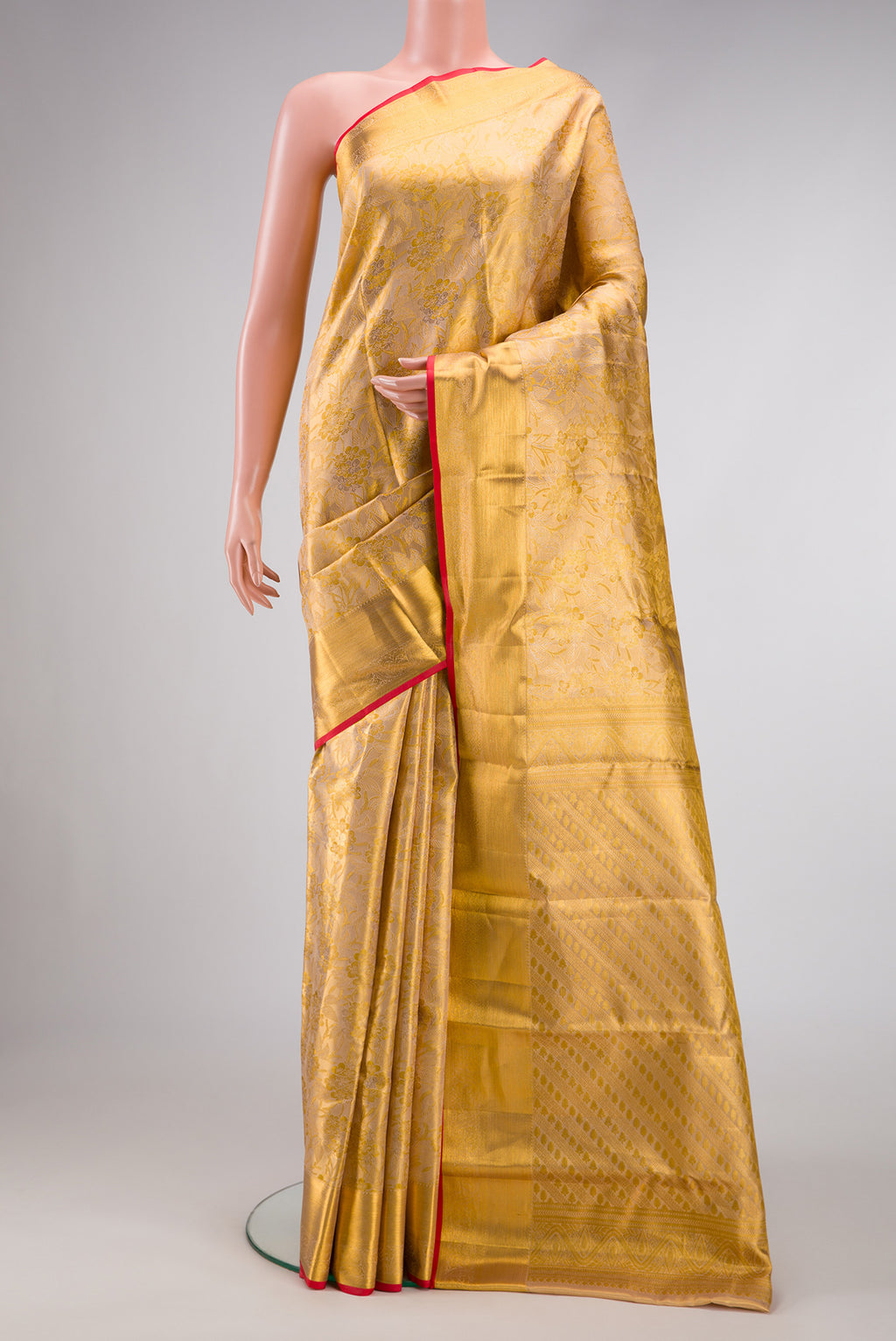 Gold Dual Tone Kanchipuram Tissue Silk Saree with Zari Brocade on the body and Zari Border.  displayed on a mannequin