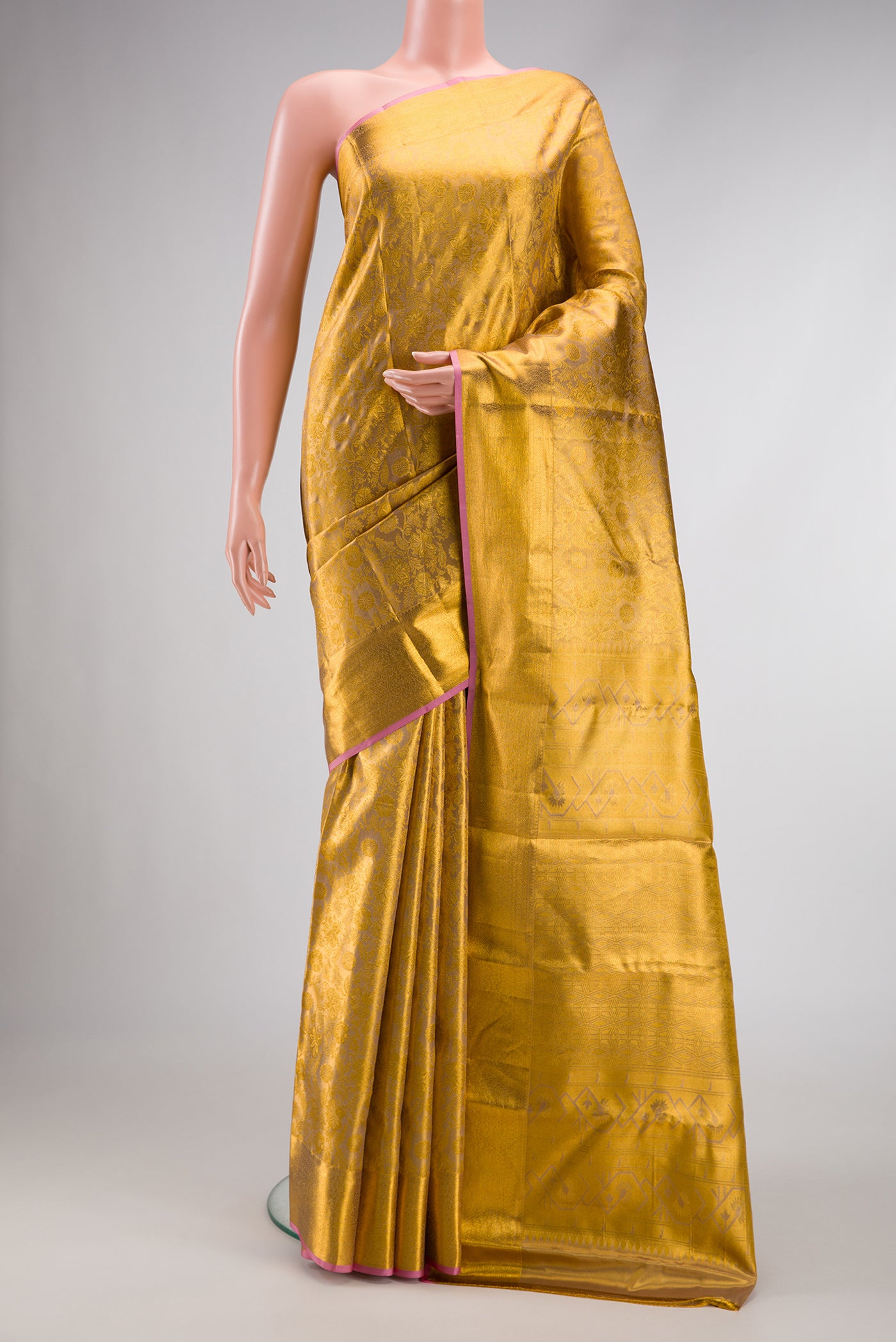 Gold Dual Tone Kanchipuram Tissue Silk Saree with Zari Brocade on the body and Zari Border.  displayed on a mannequin