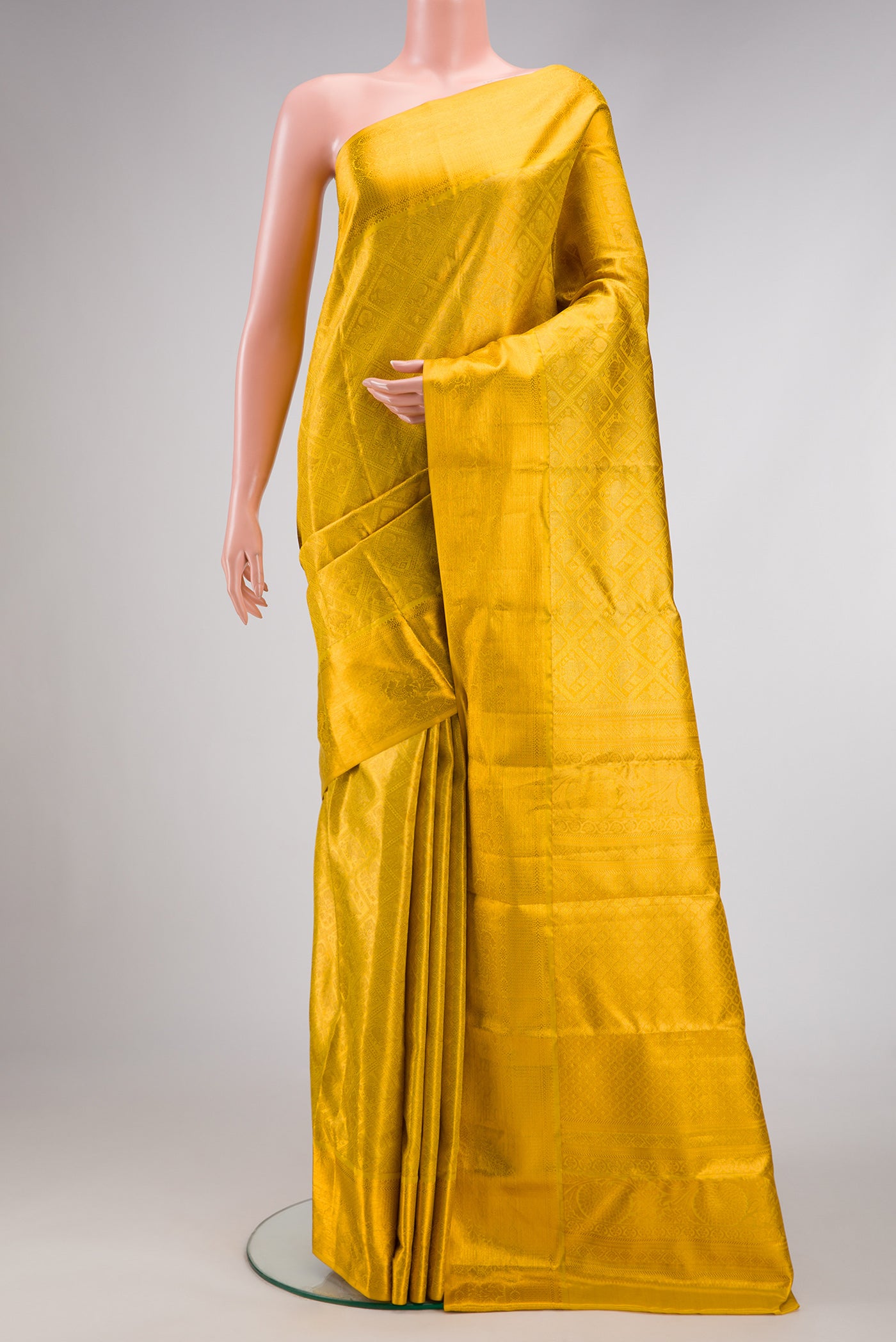 Gold Dual Tone Kanchipuram Tissue Silk Saree with Zari Brocade on the body and Zari Border.  displayed on a mannequin