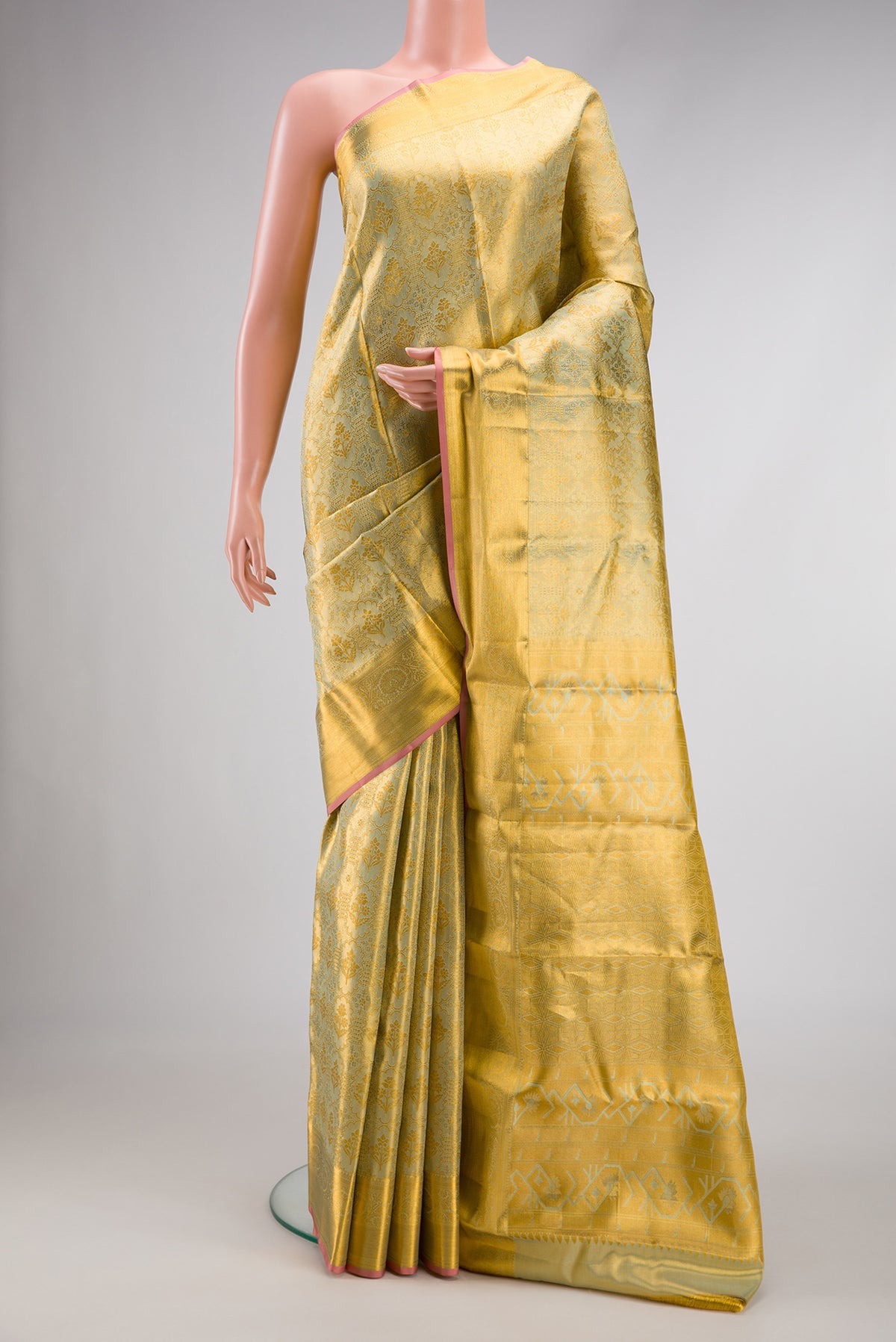 Pista Green Dual Tone Kanchipuram Tissue Silk Saree with Zari Brocade on the body and Zari Border.  displayed on a mannequin