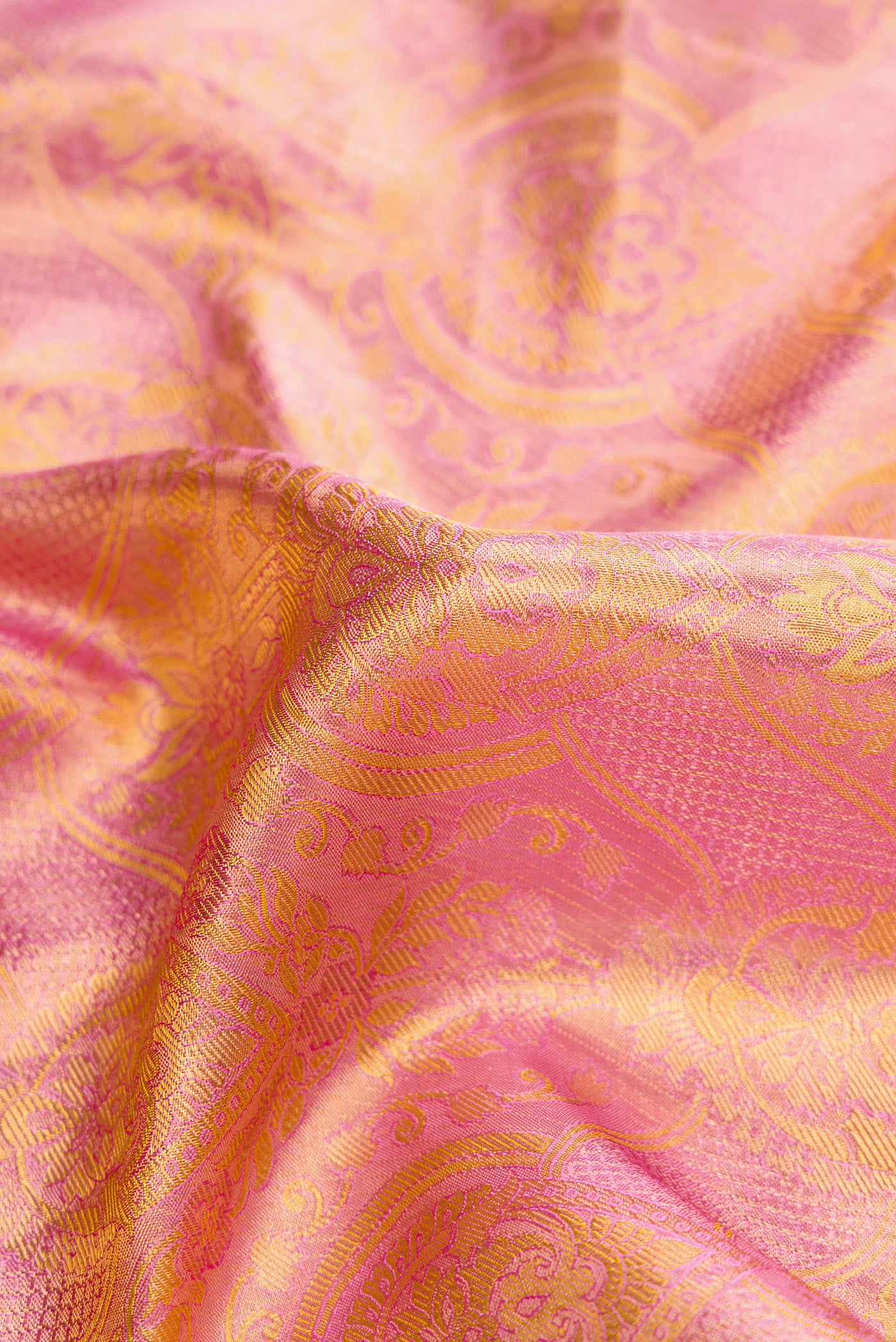 Close up of Pink Dual Tone Kanchipuram Tissue Silk Saree with Zari Brocade on the body and Zari Border.  displaying folds