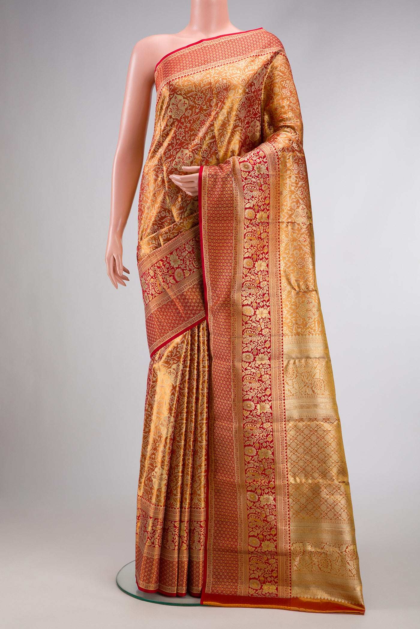 Red Dual Tone Kanjivaram Tissue Silk Saree with Zari Brocade on the body and Zari Border.  displayed on a mannequin
