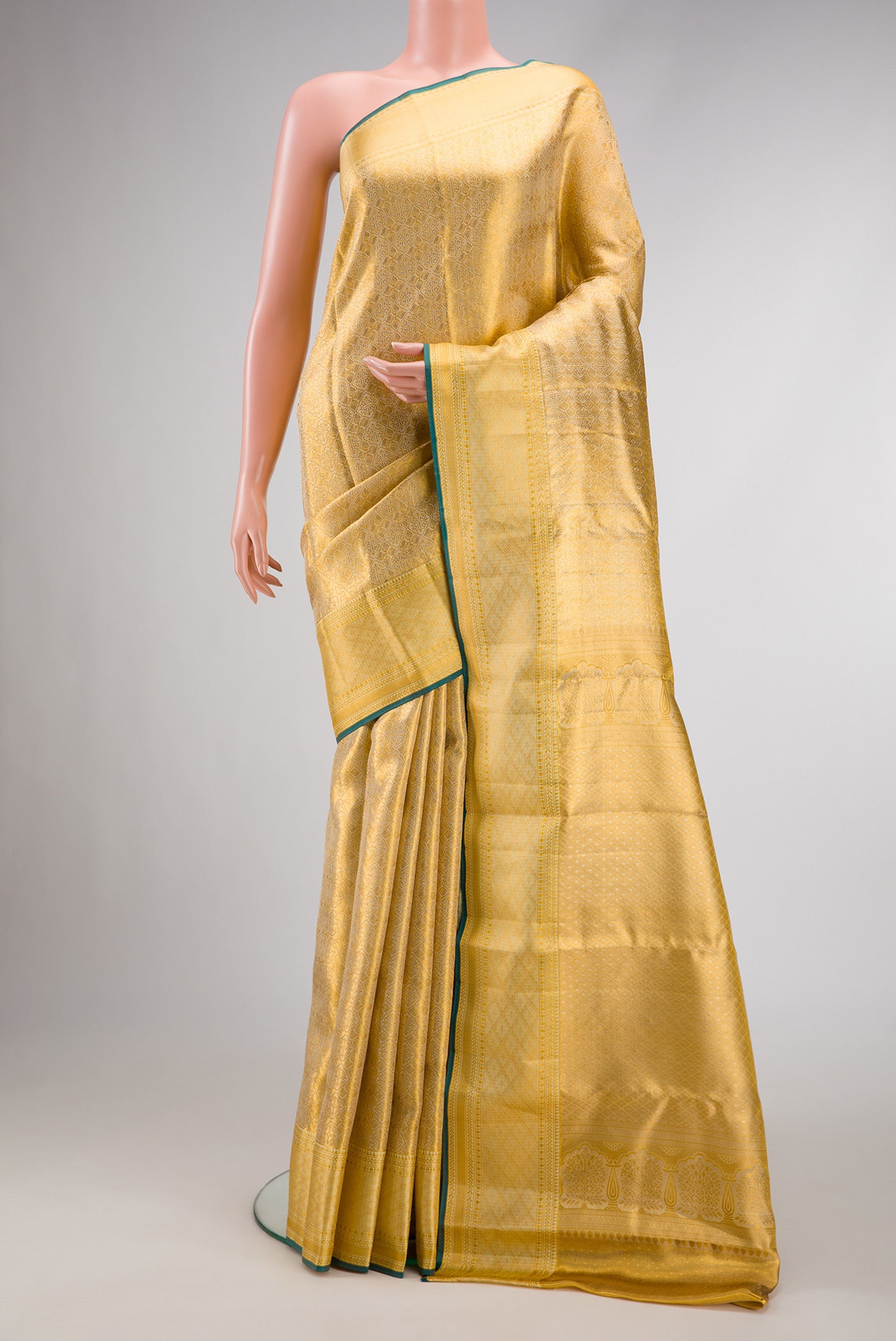 Gold Dual Tone Kanjivaram Tissue Silk Saree with Zari Brocade on the body and Zari Border.  displayed on a mannequin