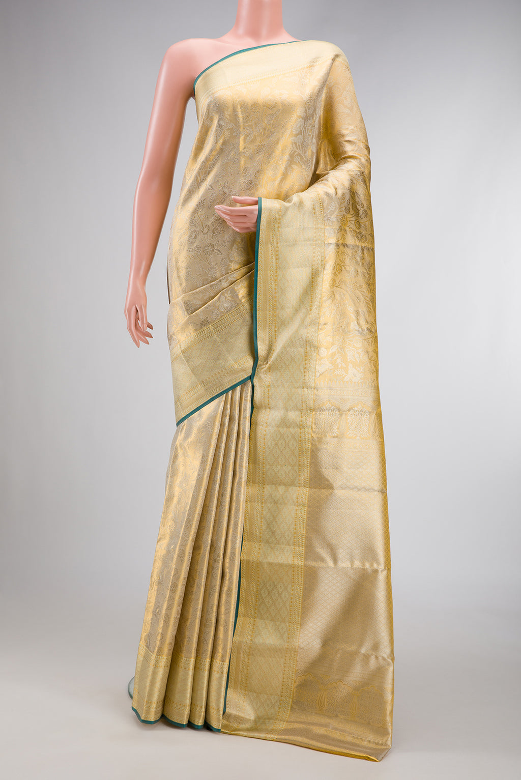 Gold Dual Tone Kanjivaram Tissue Silk Saree with Zari Butta on the body and Zari Border.  displayed on a mannequin