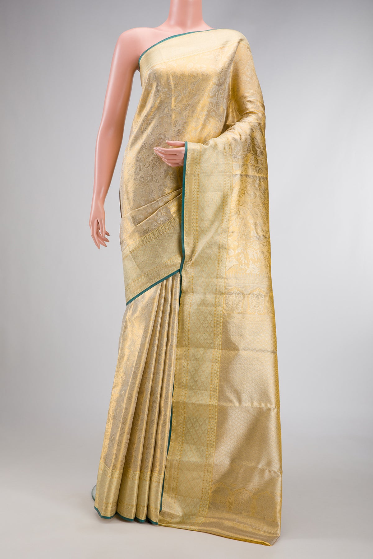 Gold Dual Tone Kanjivaram Tissue Silk Saree with Zari Butta on the body and Zari Border.  displayed on a mannequin