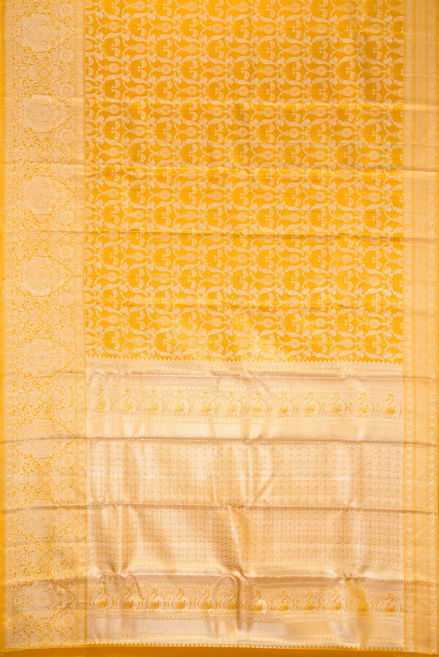 Flat view of Gold Dual Tone Kanjivaram Tissue Silk Saree with Zari Brocade on the body and Zari Border. 