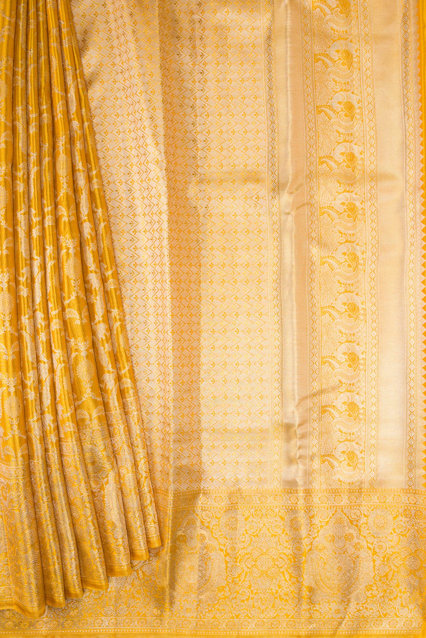 Pleats and pallu of Gold Dual Tone Kanjivaram Tissue Silk Saree with Zari Brocade on the body and Zari Border. 