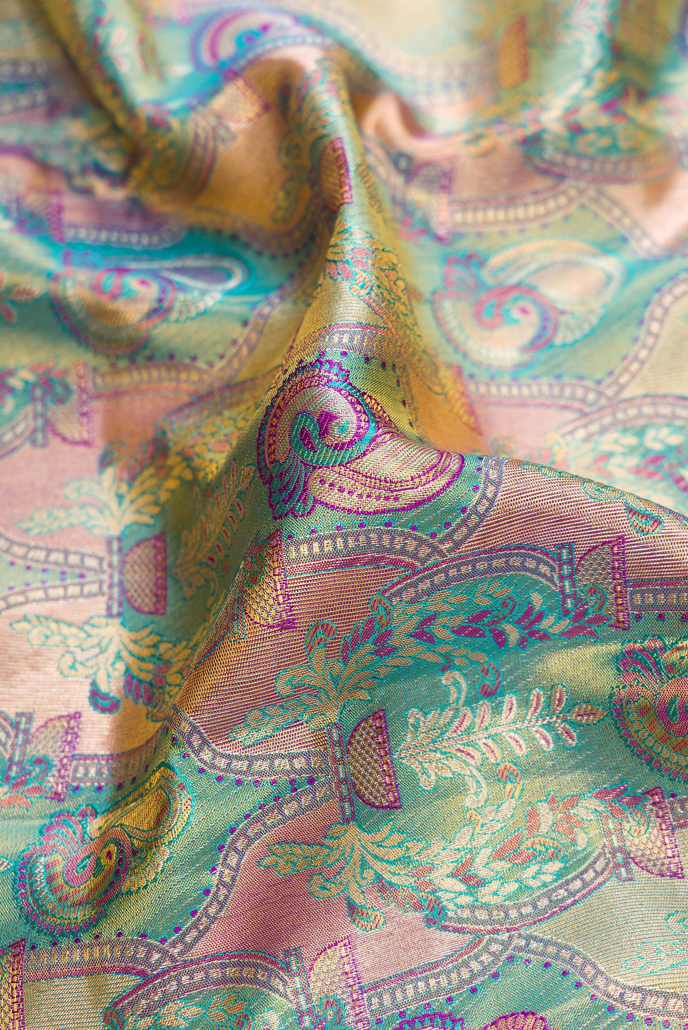 Close up of Green Dual Tone Kanjivaram Tissue Silk Saree with Zari Brocade on the body and Zari Border.  displaying folds