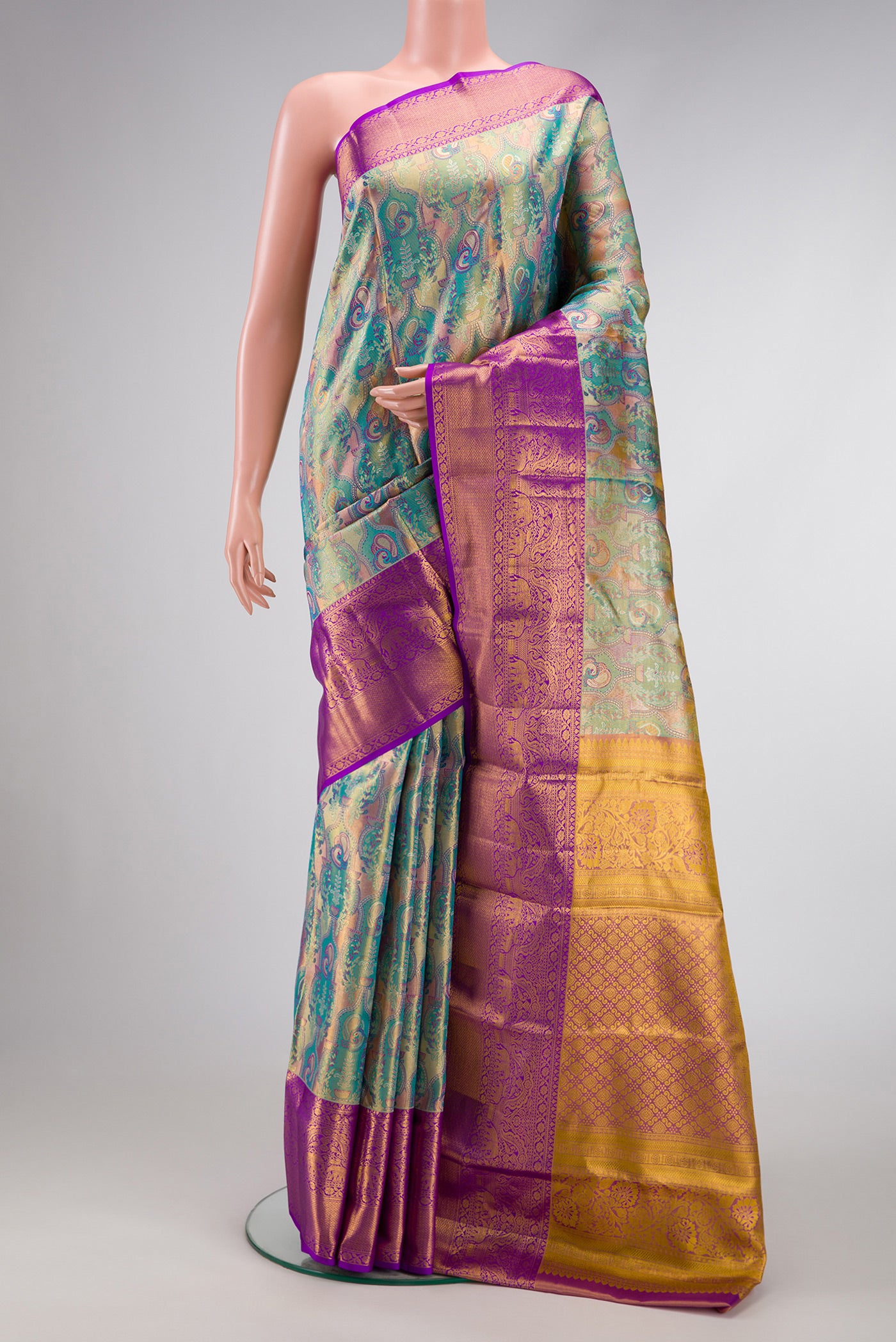 Green Dual Tone Kanjivaram Tissue Silk Saree with Zari Brocade on the body and Zari Border.  displayed on a mannequin