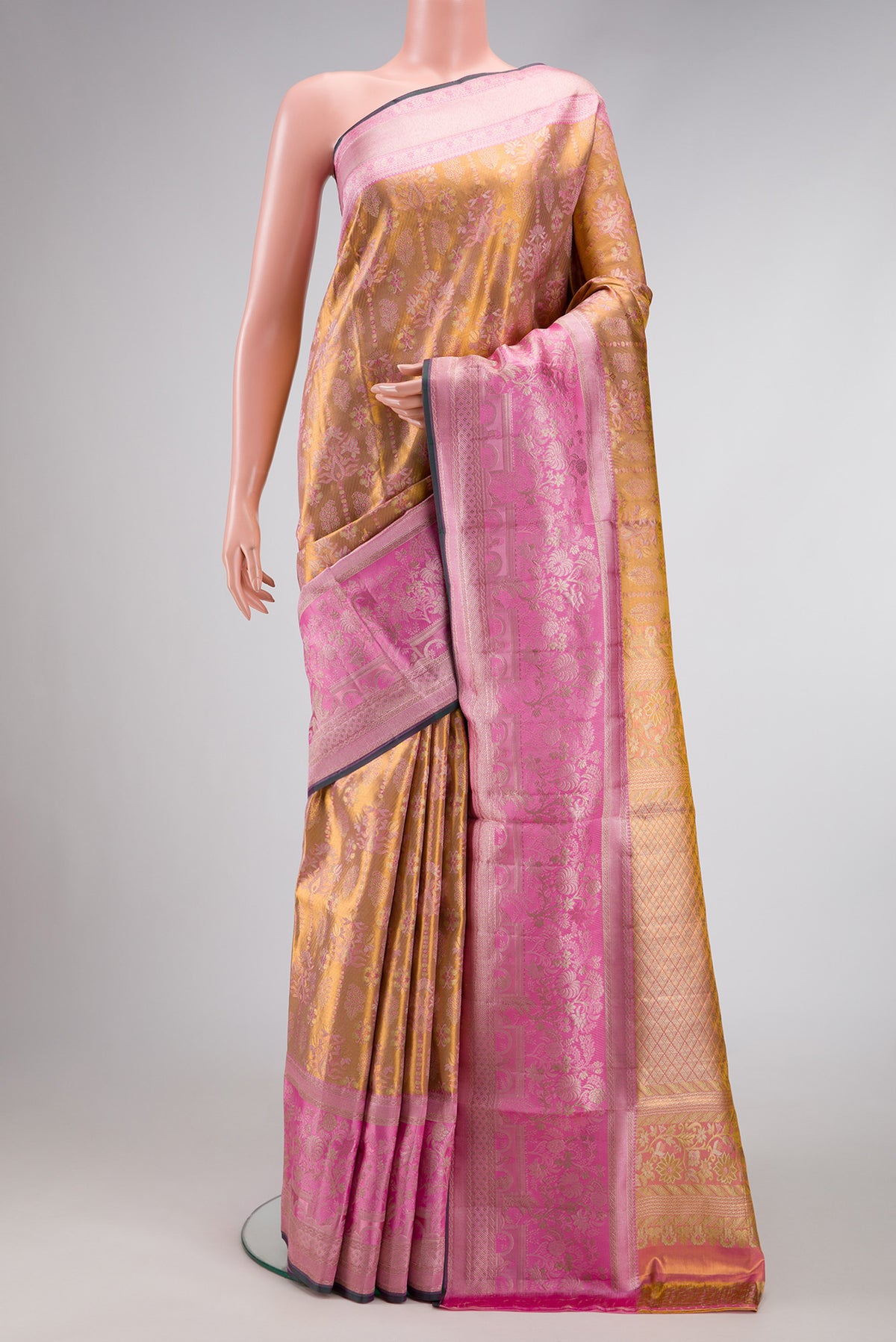 Gold Dual Tone Kanjivaram Tissue Silk Saree with Zari Brocade on the body and Zari Border.  displayed on a mannequin