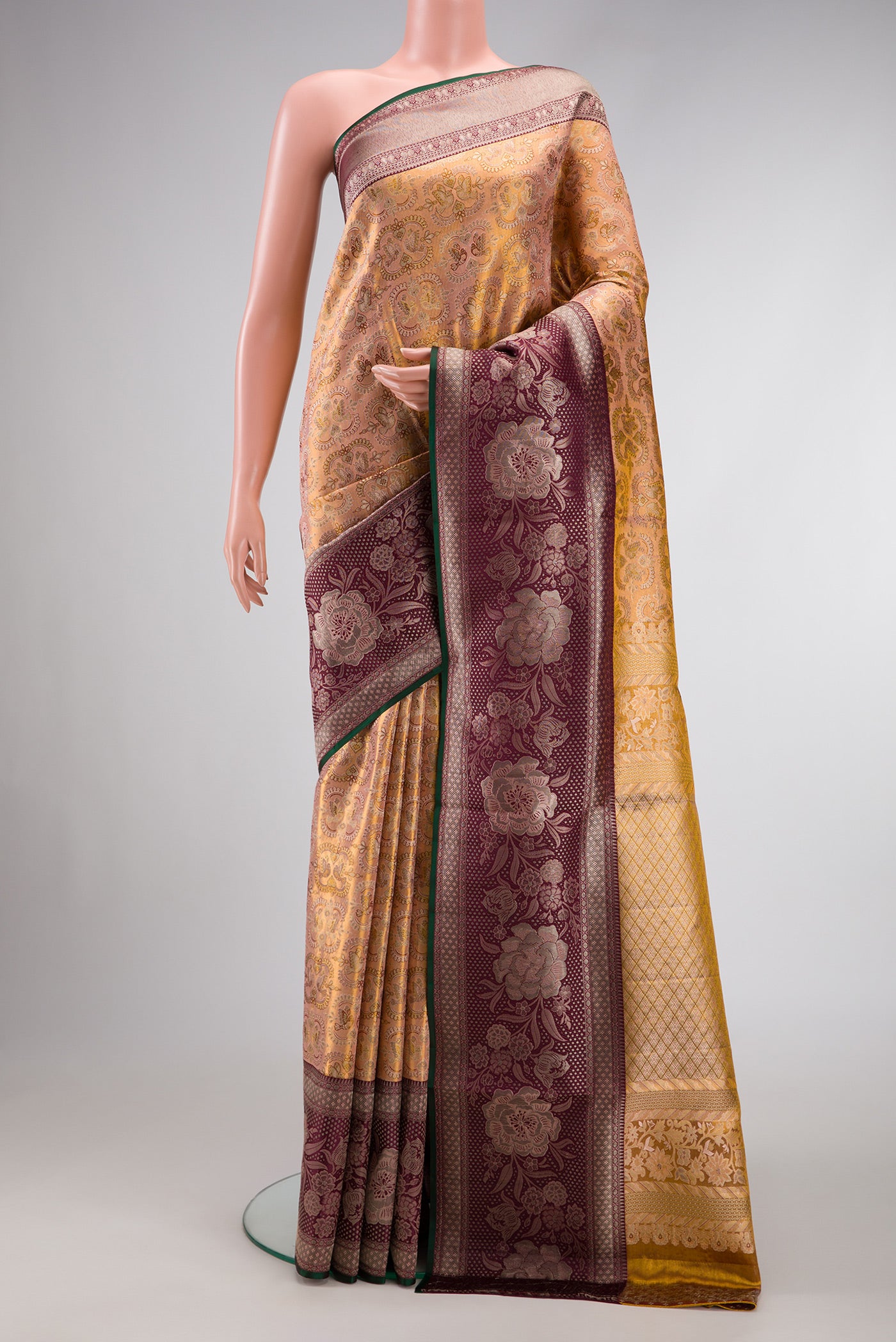 Gold Dual Tone Kanjivaram Tissue Silk Saree with Zari Brocade on the body and Zari Border.  displayed on a mannequin