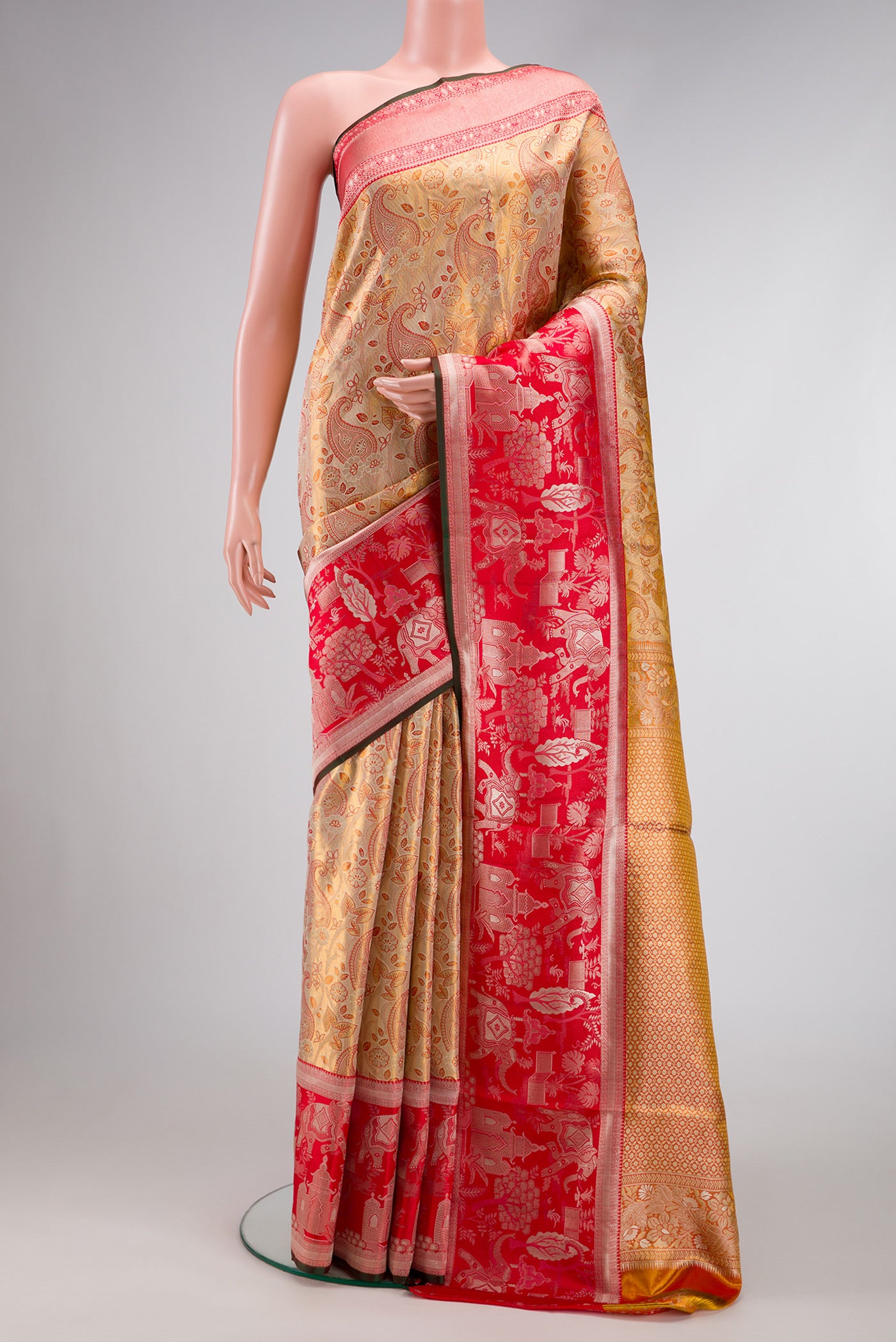 Gold Dual Tone Kanjivaram Tissue Silk Saree with Zari Brocade on the body and Fancy Border.  displayed on a mannequin