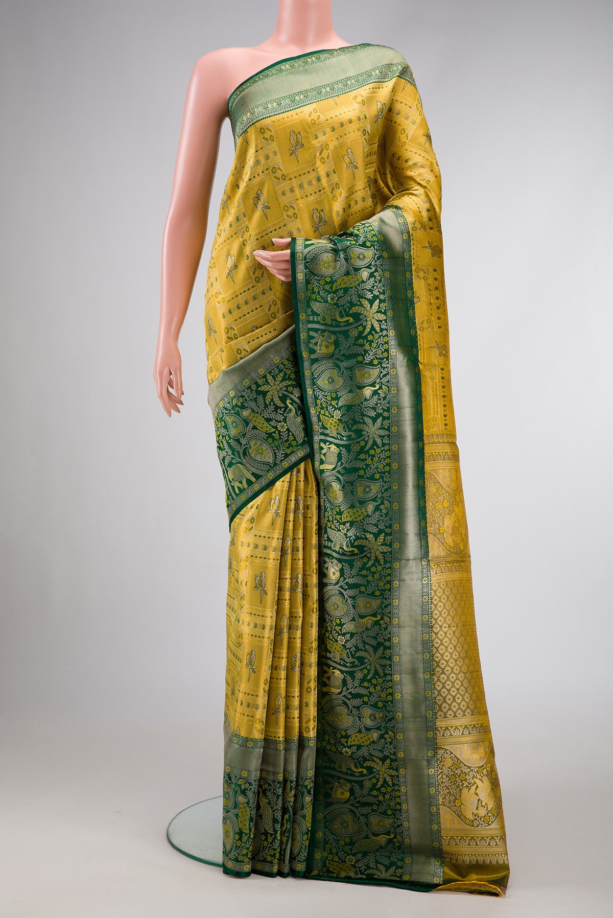 Gold Dual Tone Kanjivaram Tissue Silk Saree with Zari Brocade on the body and Zari Border.  displayed on a mannequin