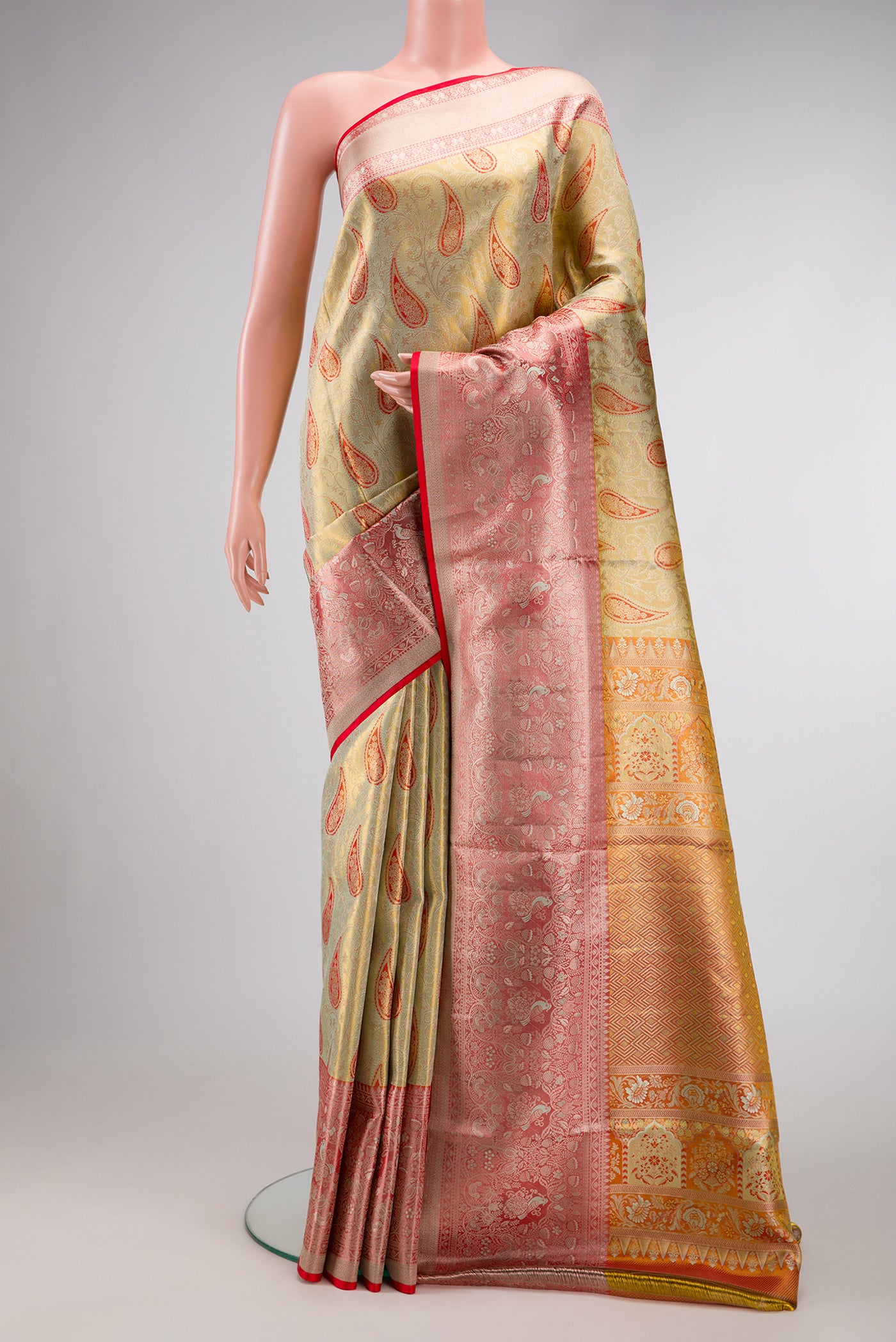 Pista Green Dual Tone Kanjivaram Tissue Silk Saree with Zari Brocade on the body and Zari Border.  displayed on a mannequin