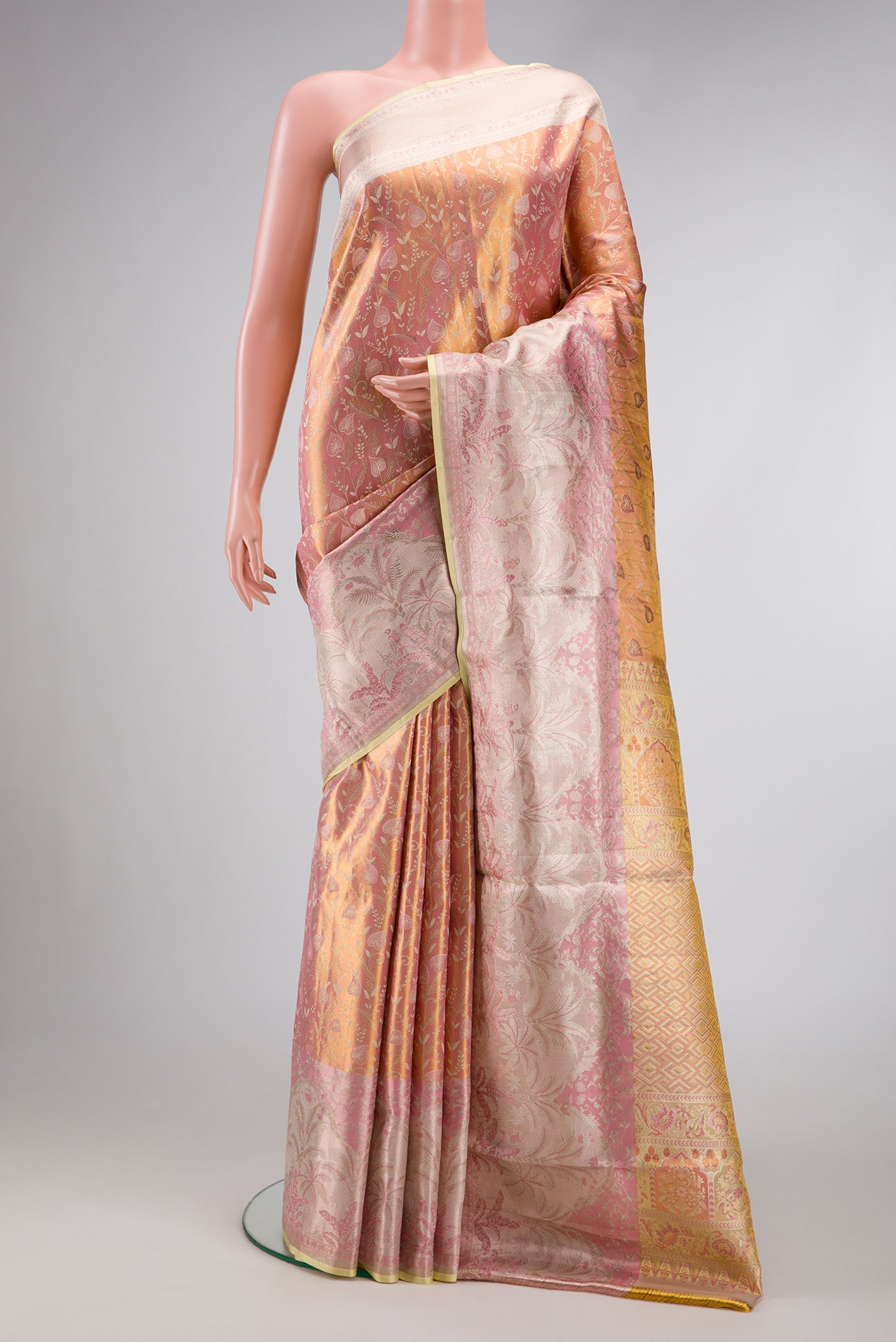 Rose Gold Dual Tone Kanjivaram Tissue Silk Saree with Zari Brocade on the body and Fancy Border.  displayed on a mannequin