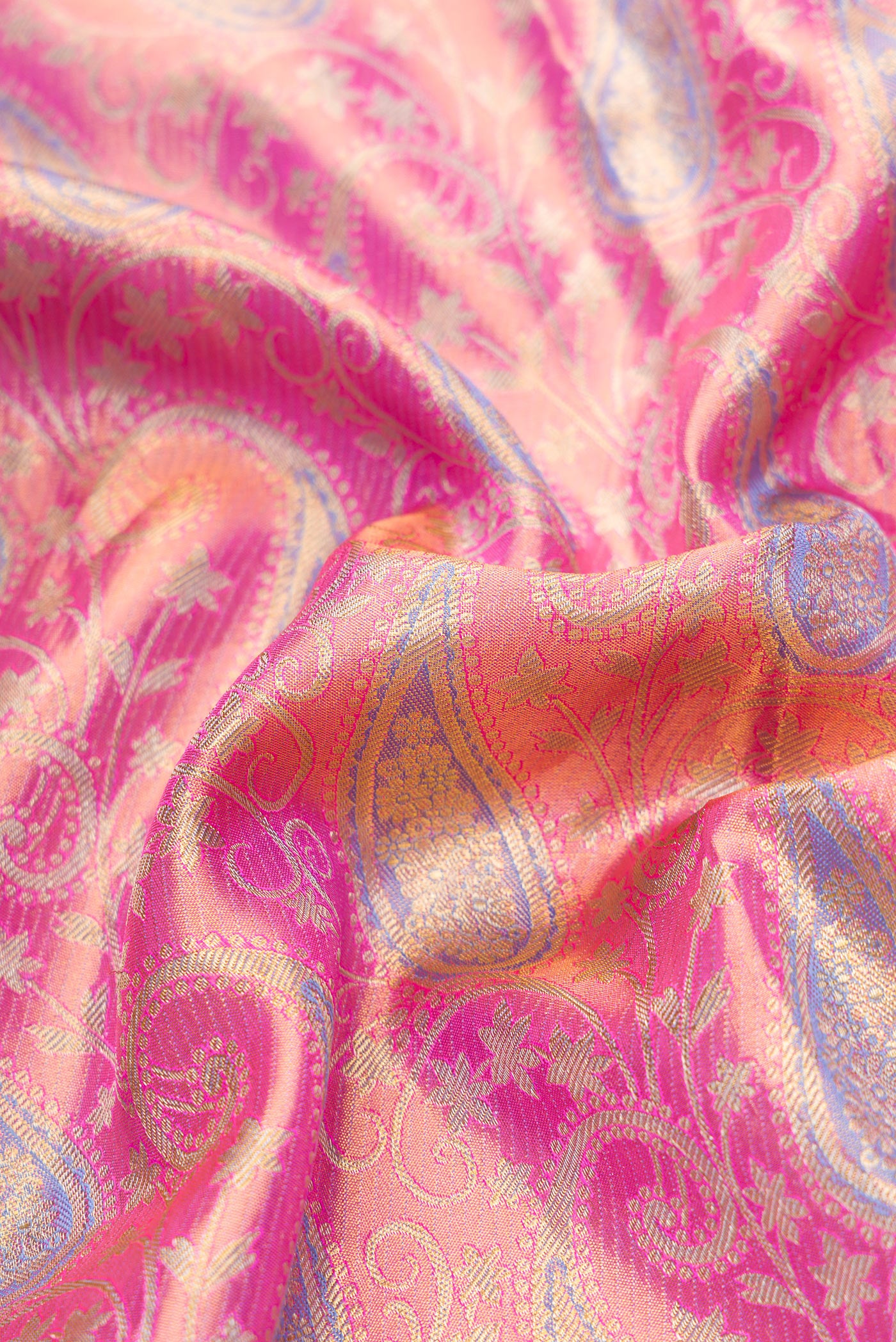 Close up of Pink Dual Tone Kanjivaram Tissue Silk Saree with Zari Brocade on the body and Zari Border.  displaying folds