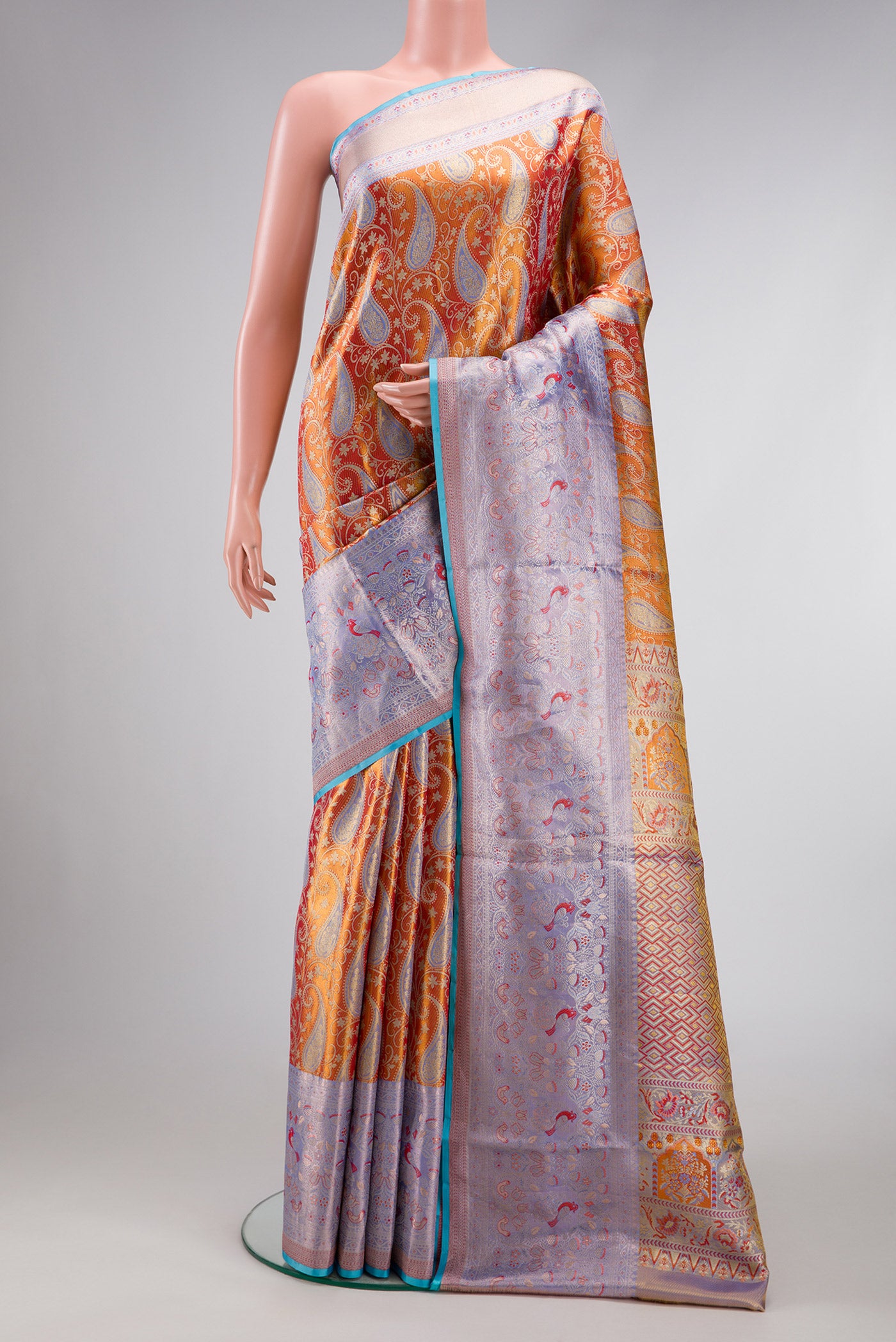 Orange Dual Tone Kanjivaram Tissue Silk Saree with Zari Brocade on the body and Fancy Border.  displayed on a mannequin