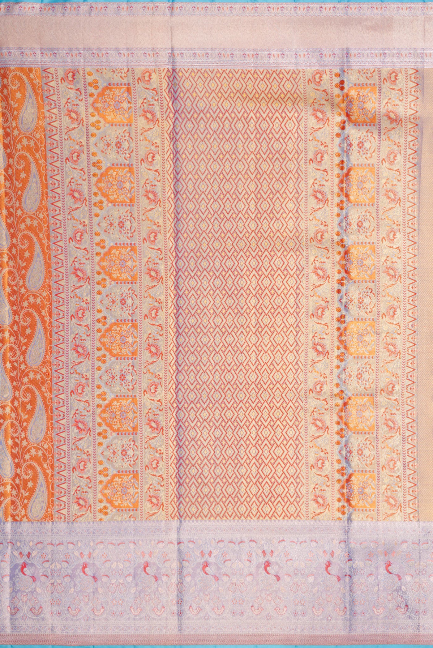 Close up image of the pallu of Orange Dual Tone Kanjivaram Tissue Silk Saree with Zari Brocade on the body and Fancy Border. 