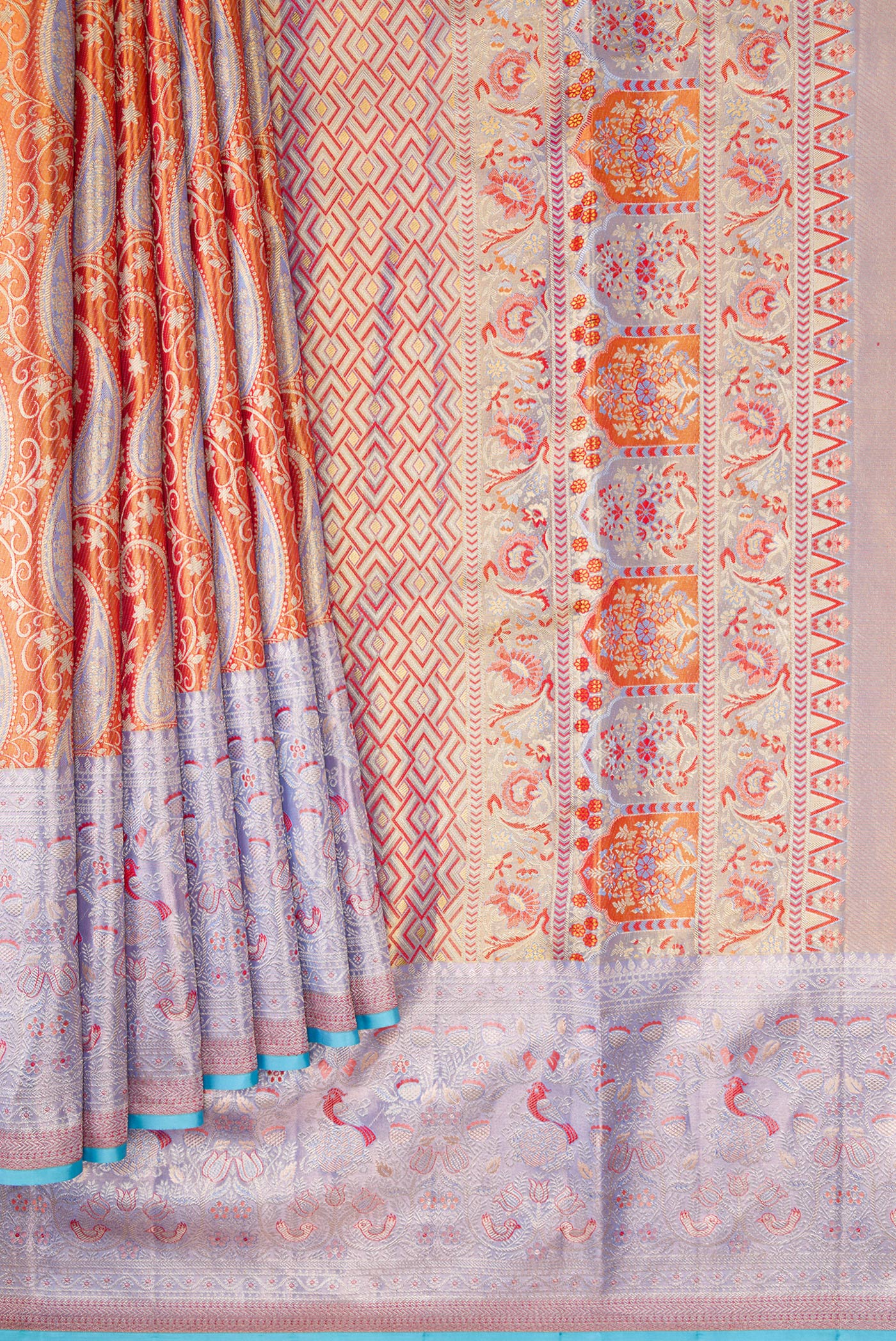 Pleats and pallu of Orange Dual Tone Kanjivaram Tissue Silk Saree with Zari Brocade on the body and Fancy Border. 