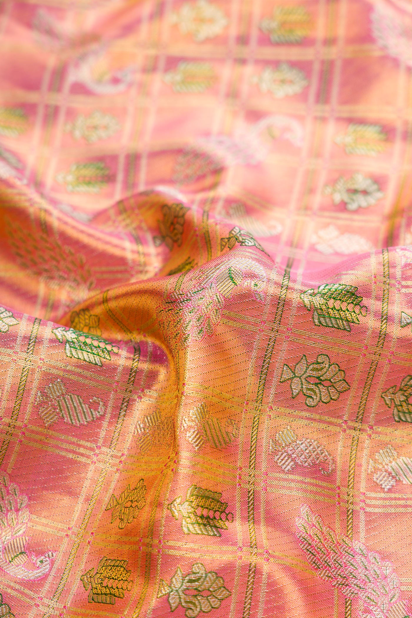 Close up of Pink Dual Tone Kanjivaram Tissue Silk Saree with Zari Brocade on the body and Fancy Border.  displaying folds