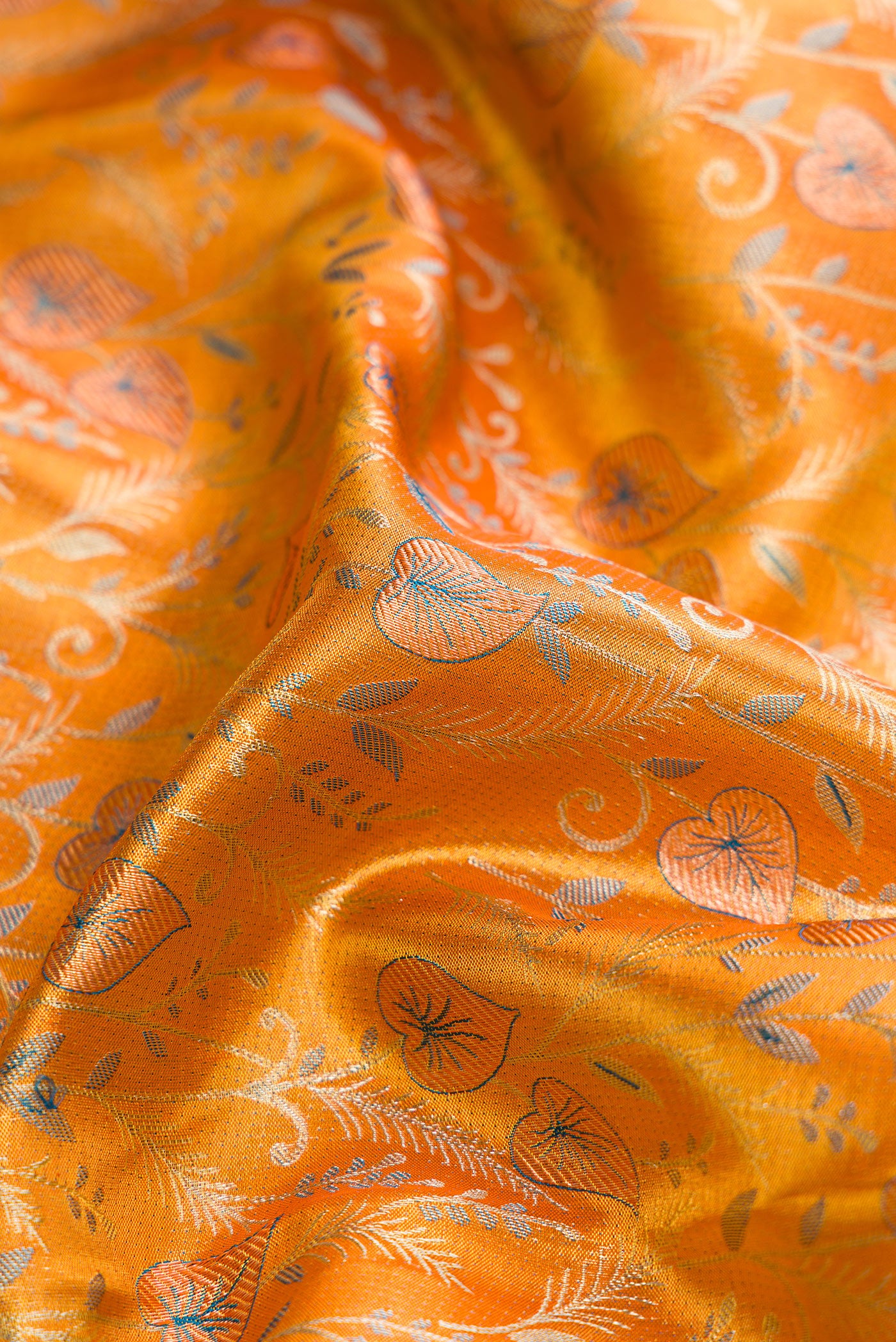 Close up of Gold Dual Tone Kanjivaram Tissue Silk Saree with Zari Brocade on the body and Fancy Border.  displaying folds