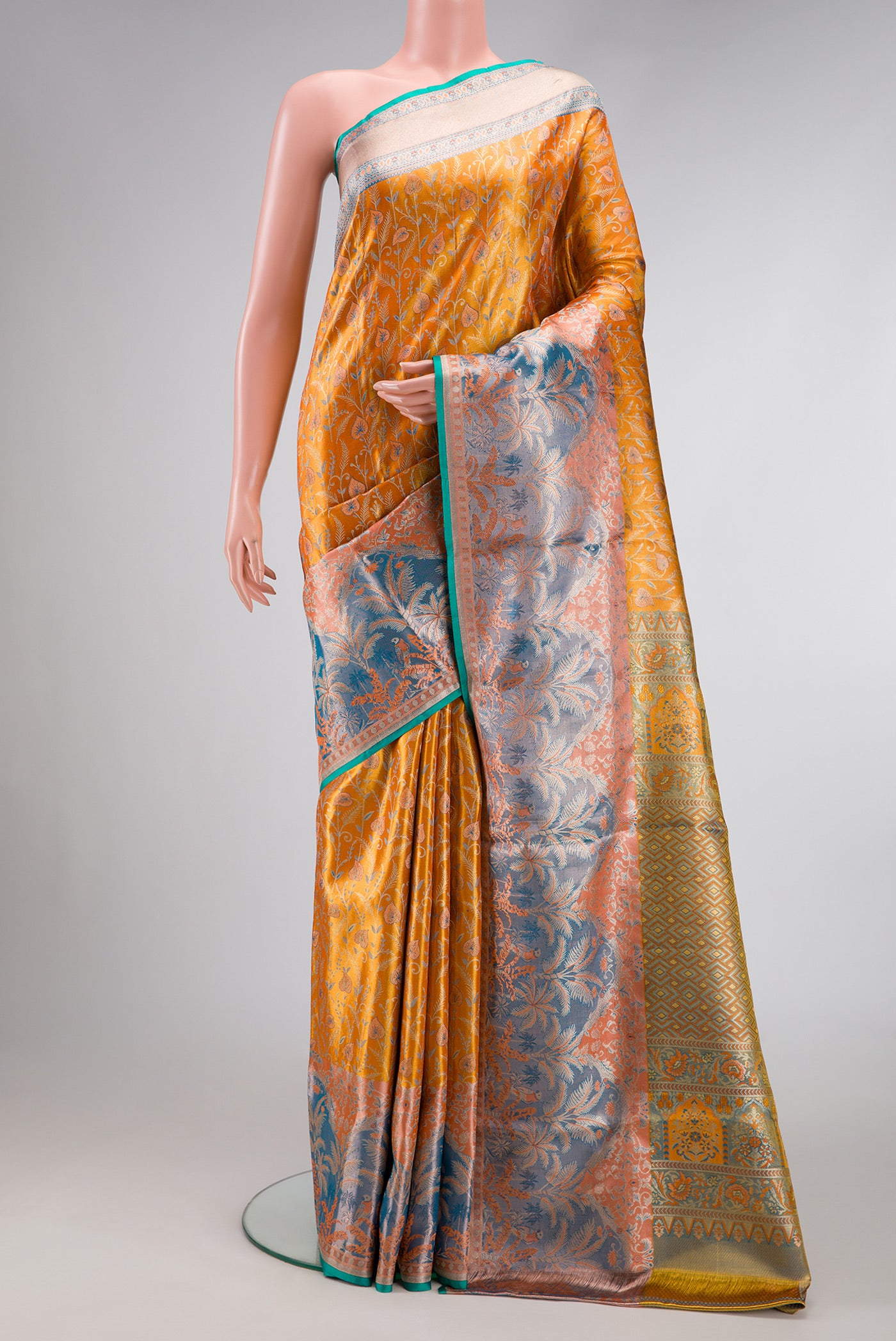 Gold Dual Tone Kanjivaram Tissue Silk Saree with Zari Brocade on the body and Fancy Border.  displayed on a mannequin