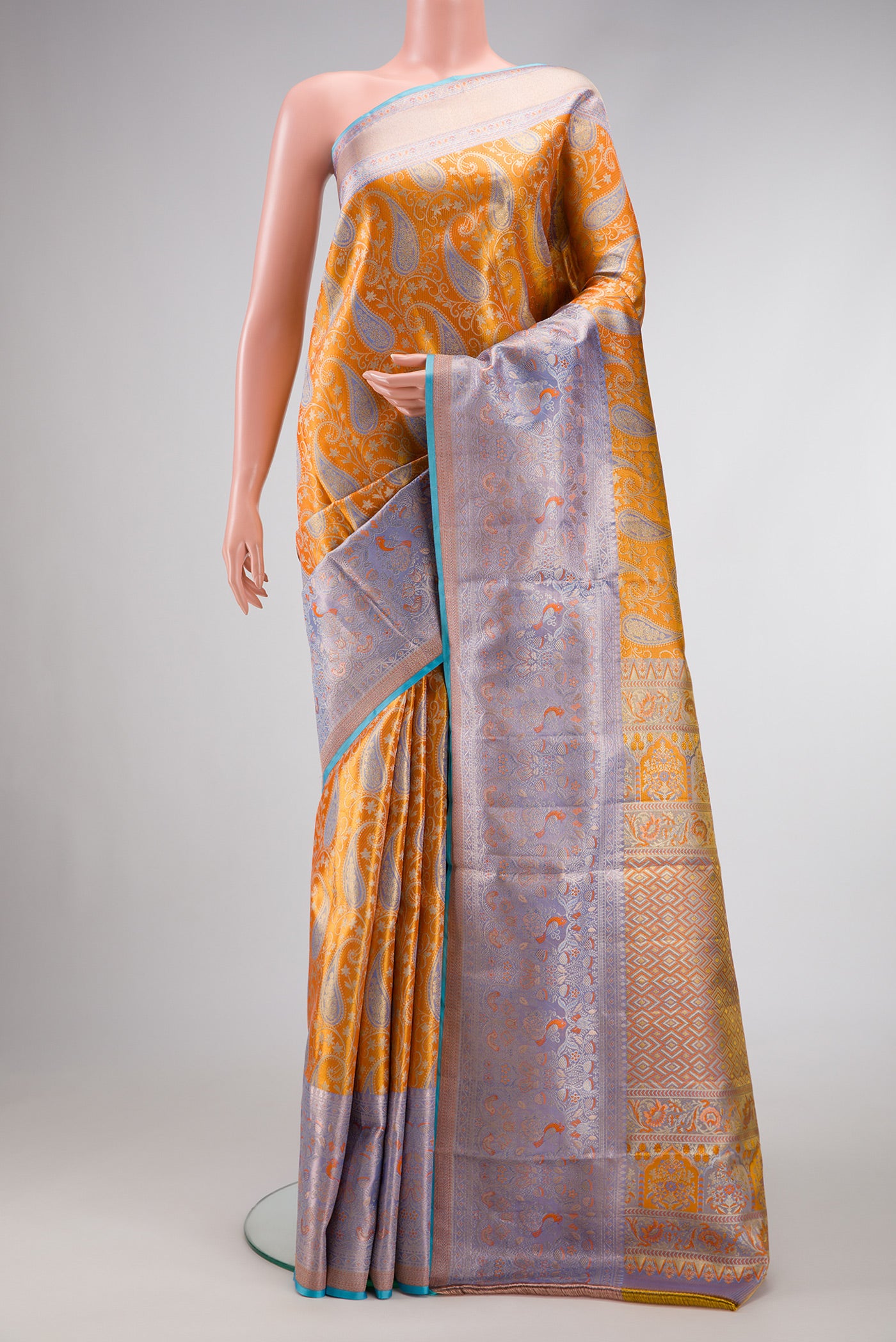 Orange Dual Tone Kanjivaram Tissue Silk Saree with Zari Brocade on the body and Zari Border.  displayed on a mannequin