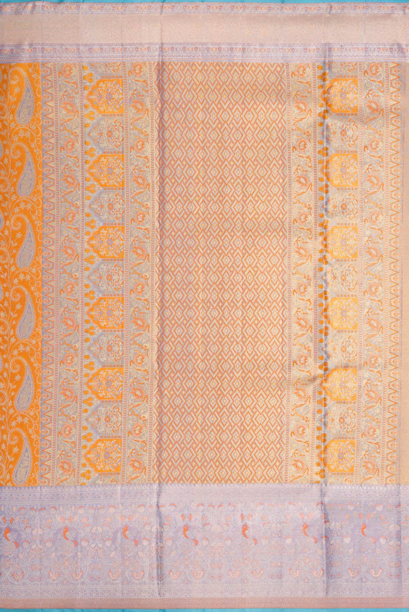 Close up image of the pallu of Orange Dual Tone Kanjivaram Tissue Silk Saree with Zari Brocade on the body and Zari Border. 