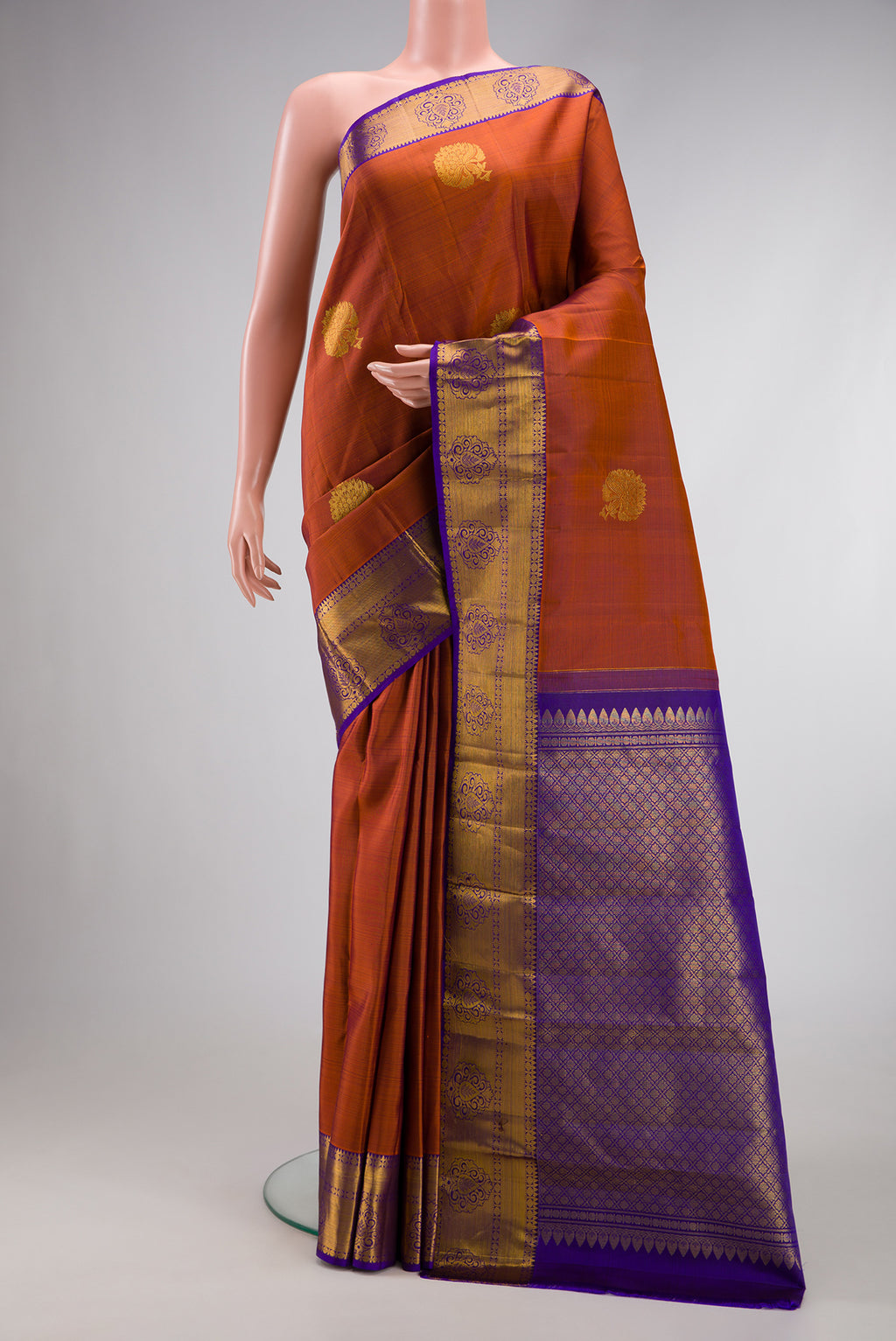 Brown Dual Tone Kanjivaram Silk Saree with Zari Butta on the body and Zari Border.  displayed on a mannequin