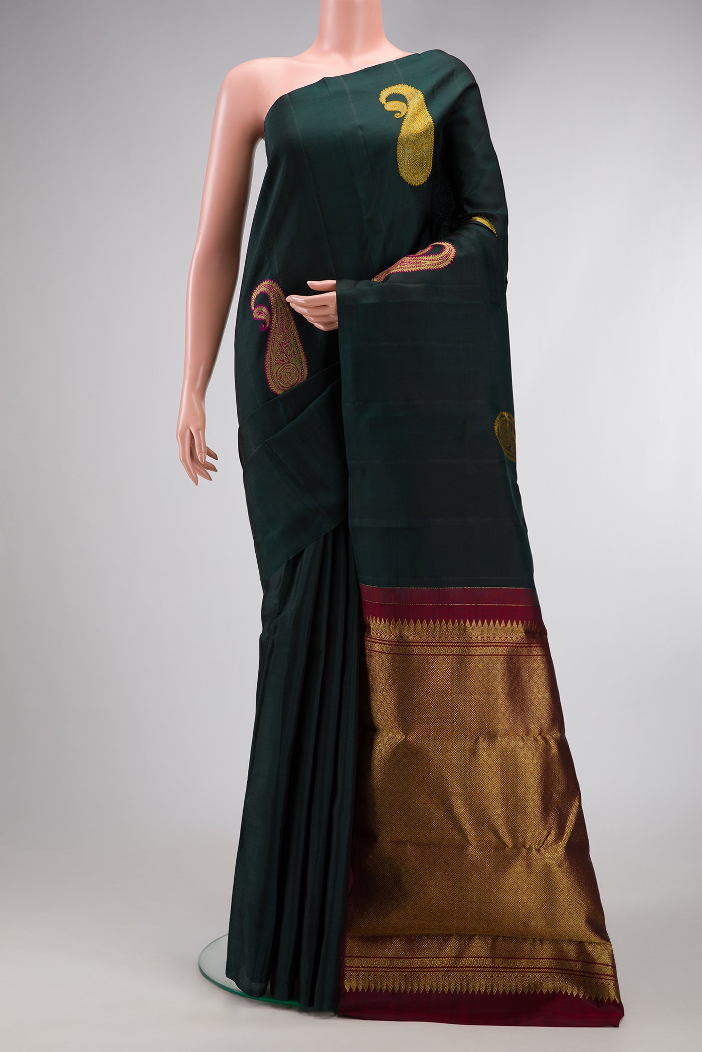 Bottle Green Dual Tone Kanchipuram Silk Saree with Zari And Thread Butta on the body and Without Border.  displayed on a mannequin