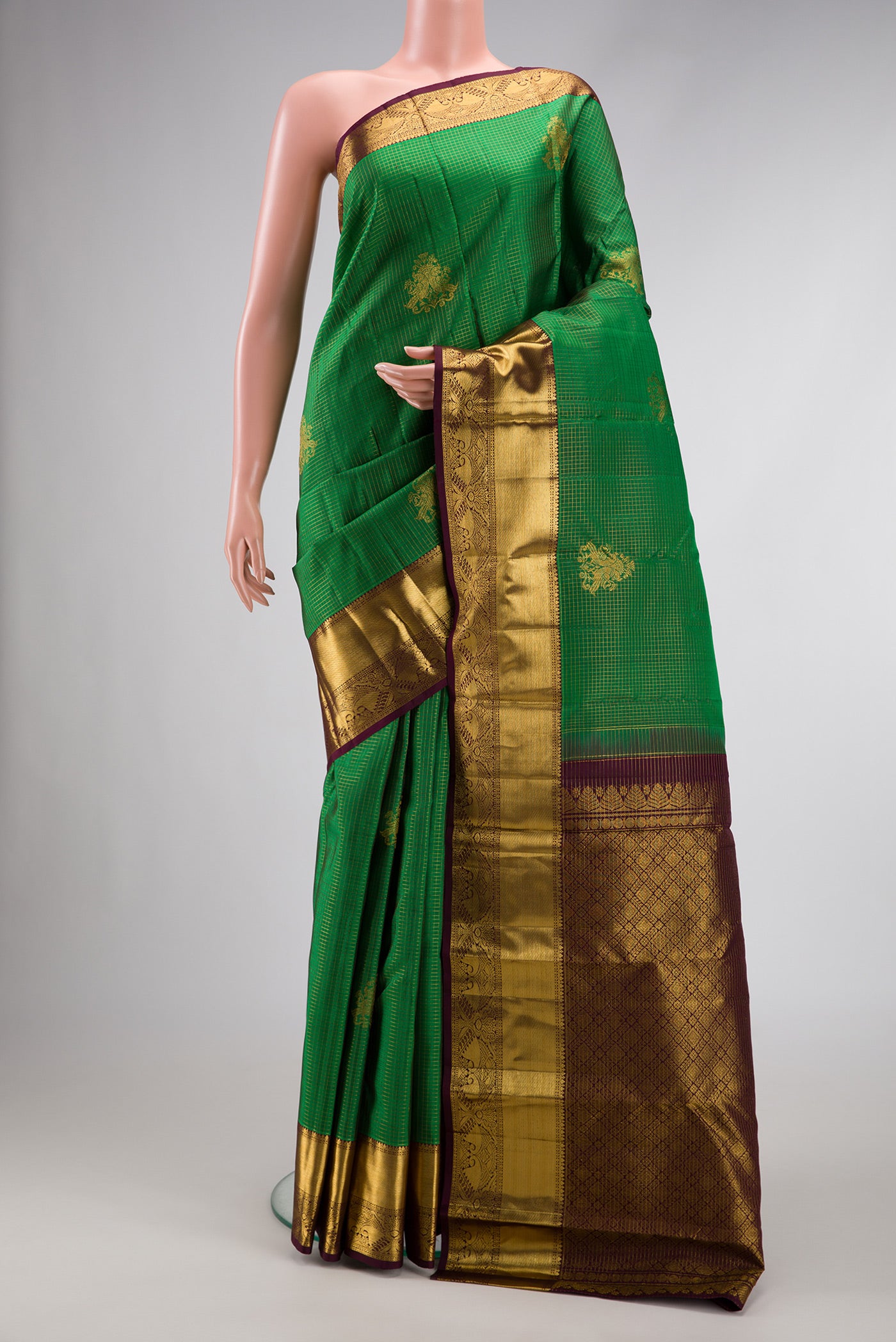 Green Dual Tone Kanchipuram Silk Saree with Stripes on the body and Zari Border.  displayed on a mannequin
