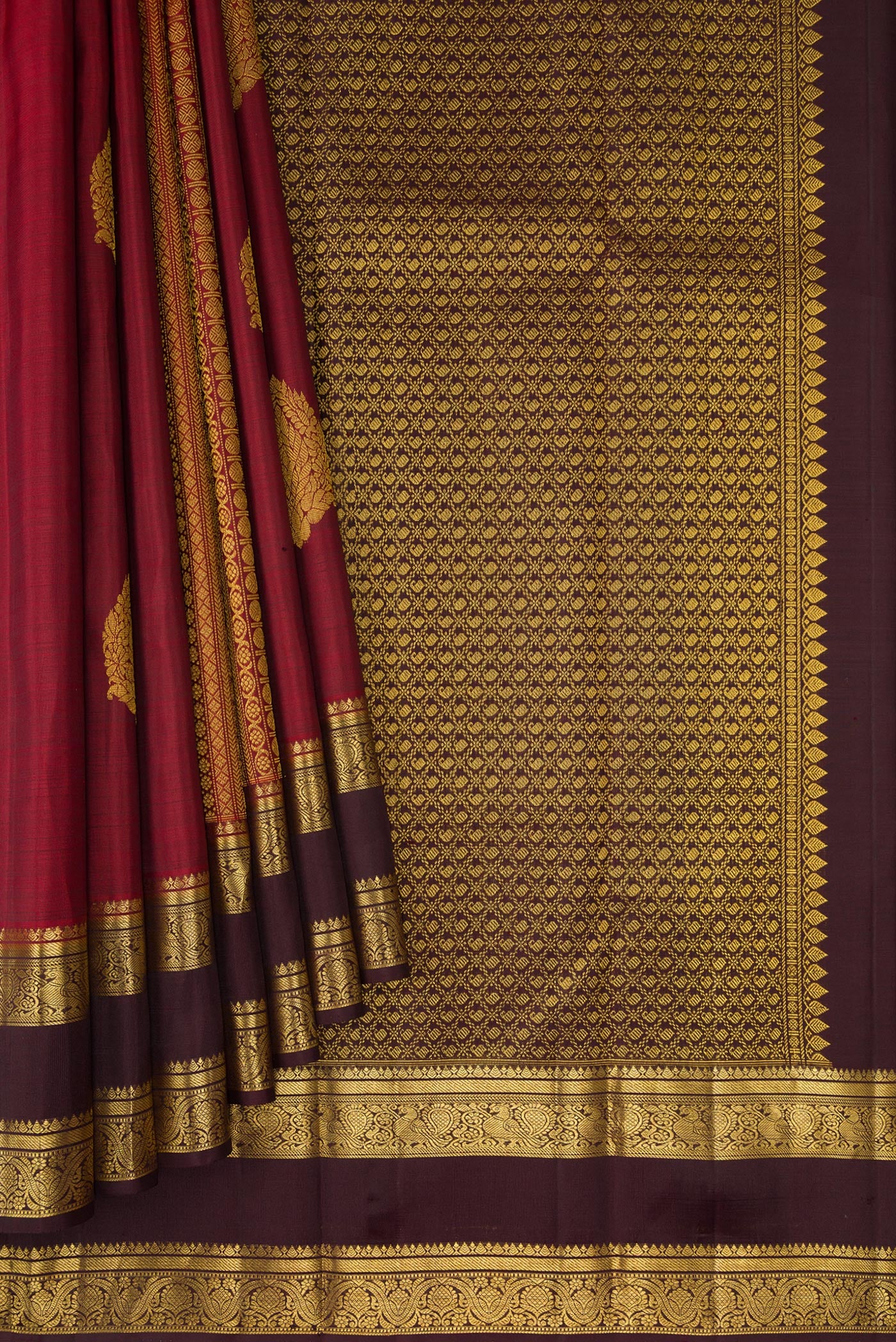 Pleats and pallu of Maroon Kanchipuram Silk Saree with Stripes on the body and Zari Border. 
