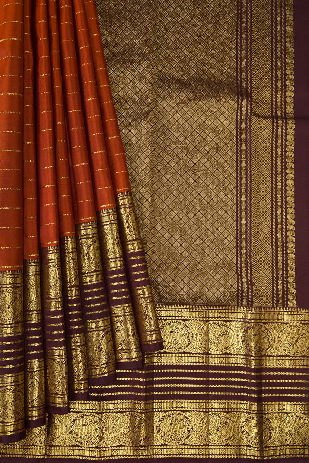 Pleats and pallu of Brick Orange Dual Tone Kanchipuram Silk Saree with Stripes on the body and Zari Border. 