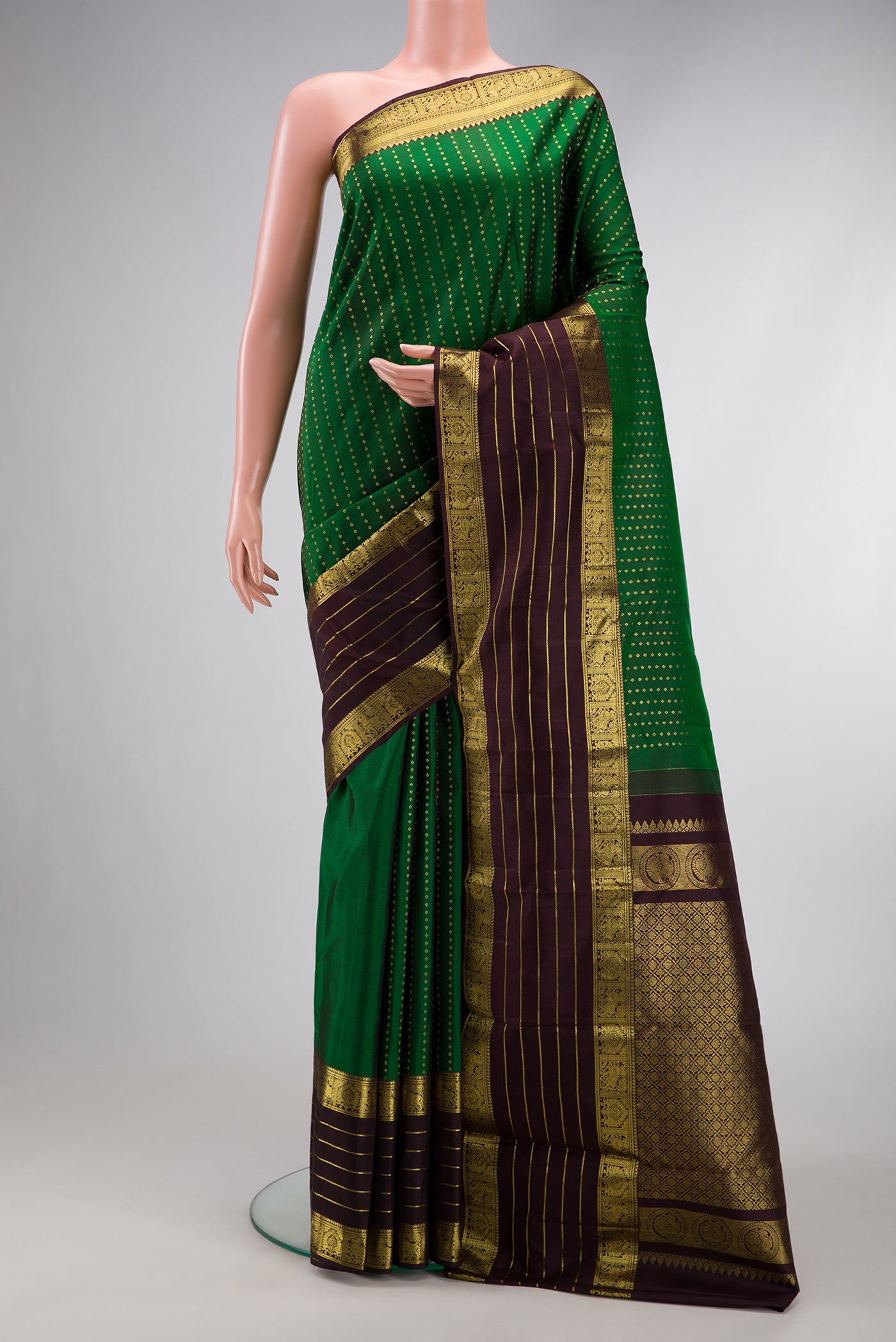 Bottle Green Dual Tone Kanchipuram Silk Saree with Stripes on the body and Zari Border.  displayed on a mannequin