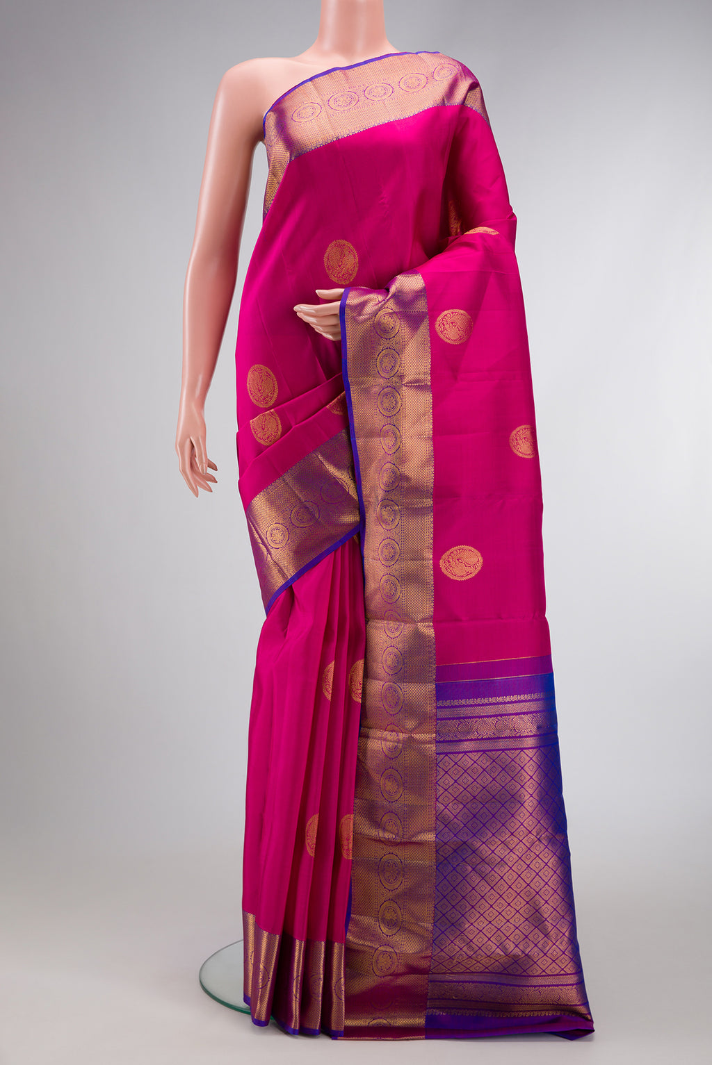 Dark Pink Dual Tone Kanjivaram Silk Saree with Zari Butta on the body and Zari Border.  displayed on a mannequin