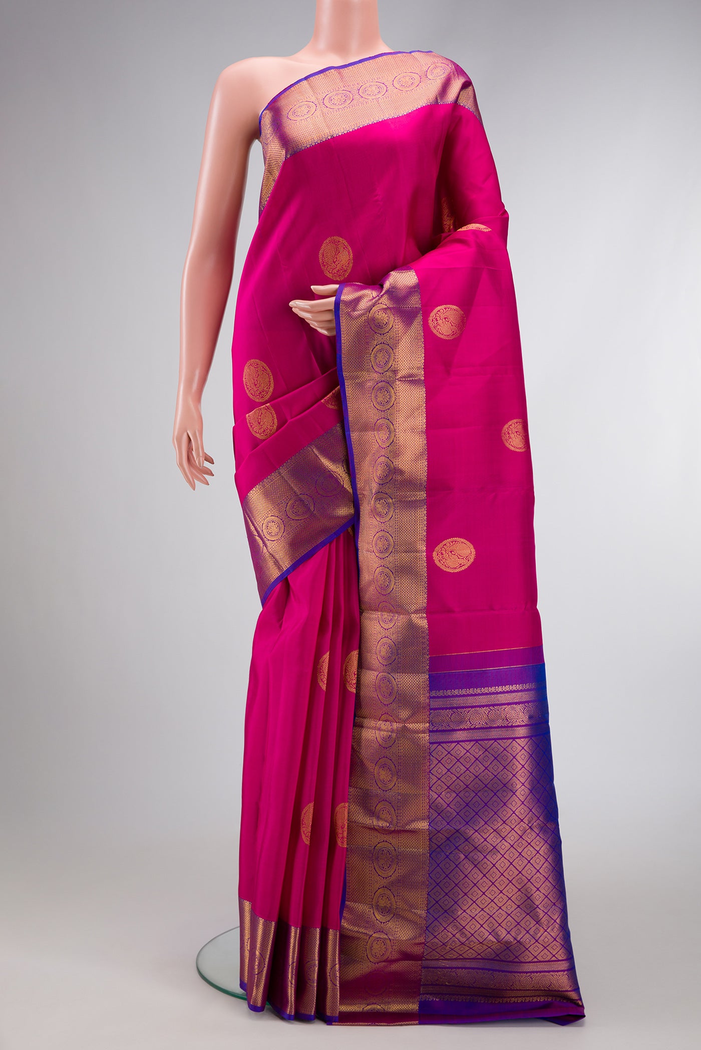 Dark Pink Dual Tone Kanjivaram Silk Saree with Zari Butta on the body and Zari Border.  displayed on a mannequin