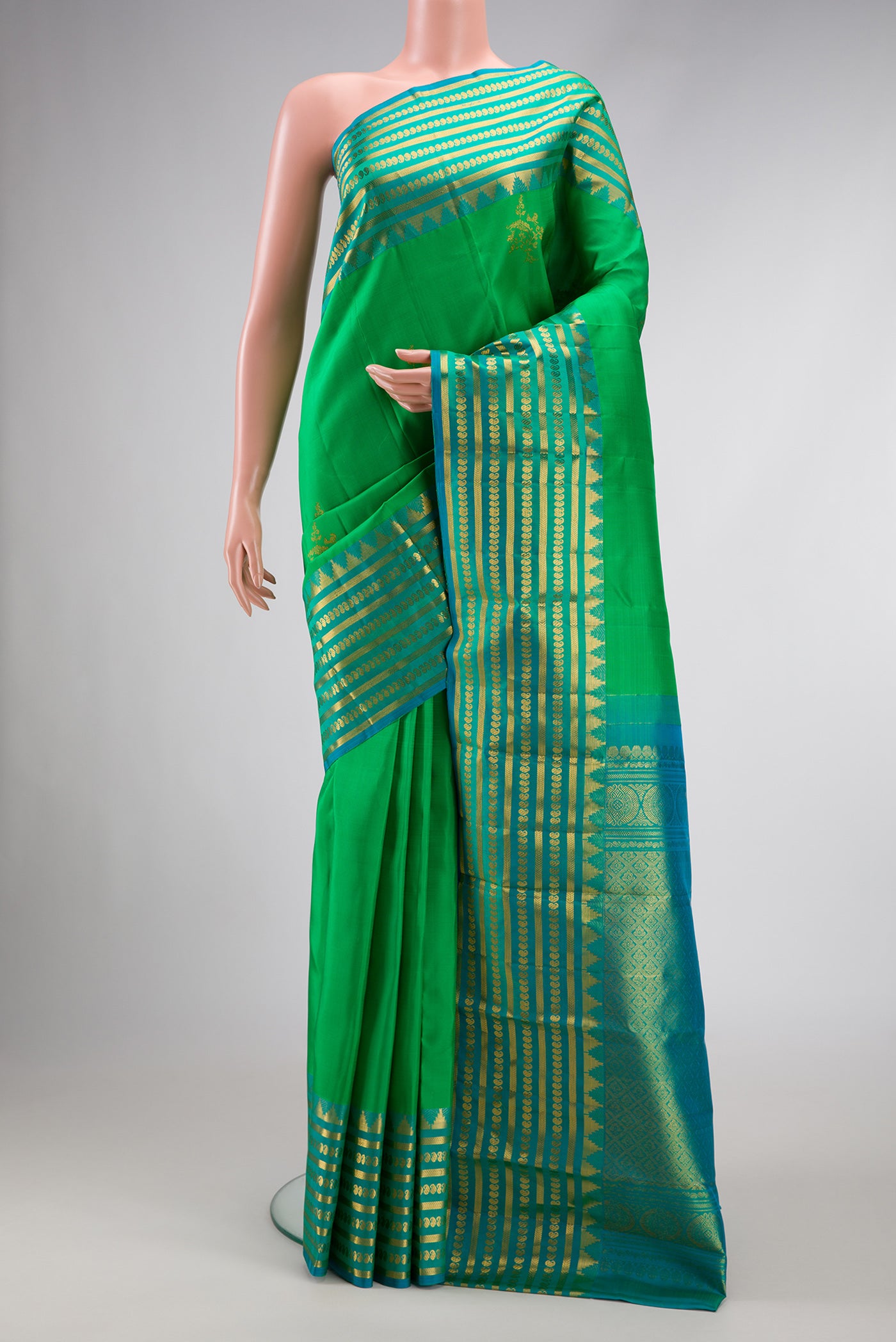 Green Dual Tone Kanchipuram Silk Saree with Zari Butta on the body and Zari Border.  displayed on a mannequin