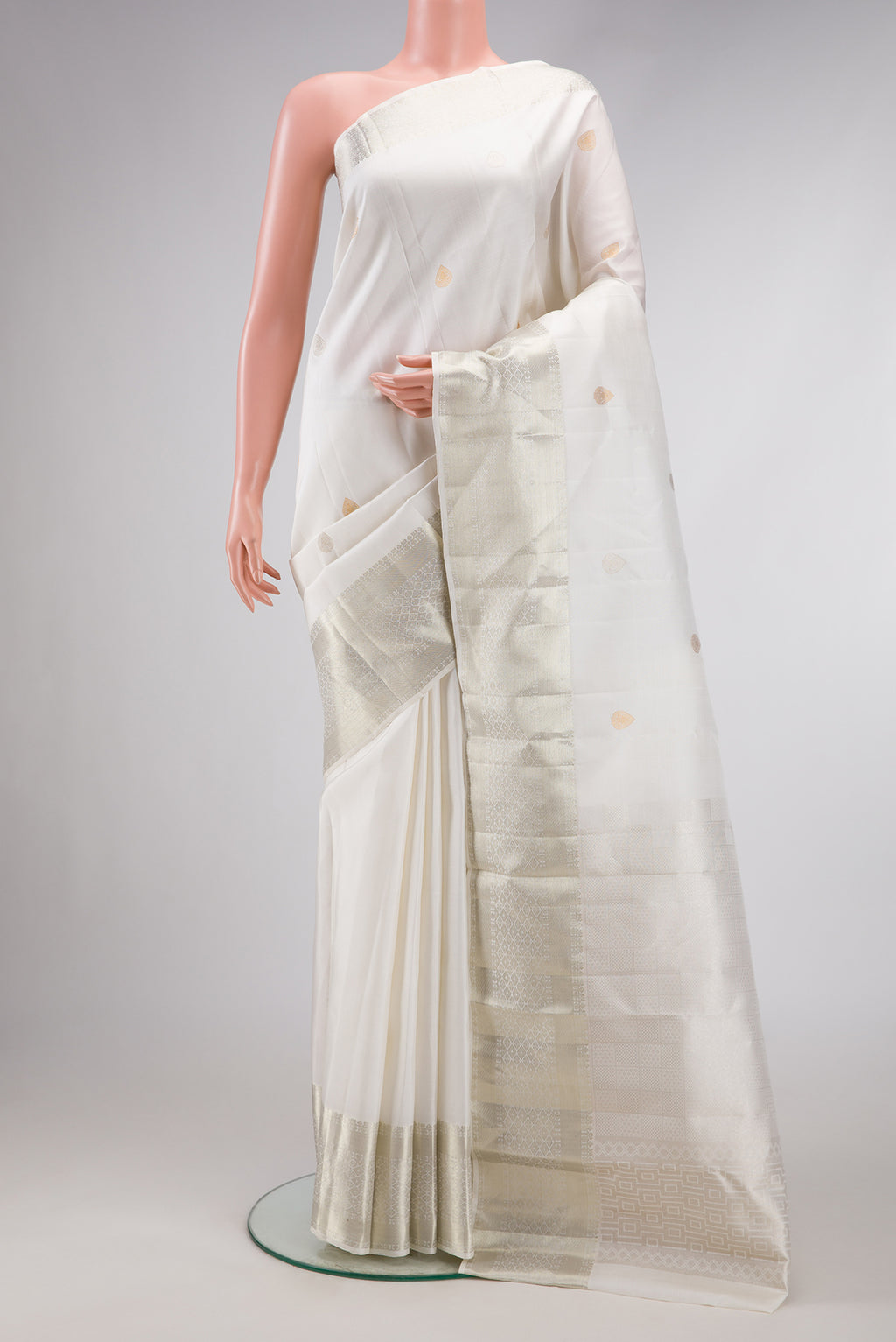 White Dual Tone Kanchipuram Silk Saree with Zari Butta on the body and Zari Border.  displayed on a mannequin