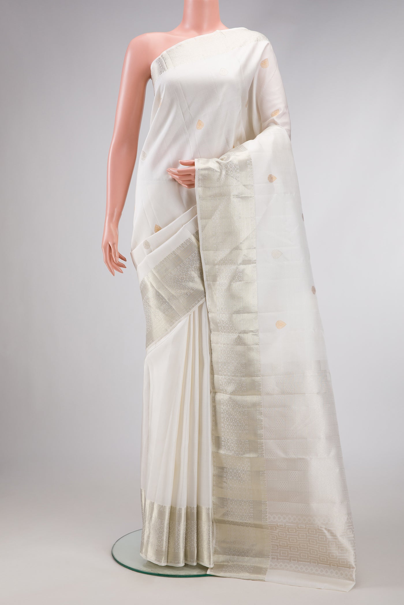 White Dual Tone Kanchipuram Silk Saree with Zari Butta on the body and Zari Border.  displayed on a mannequin