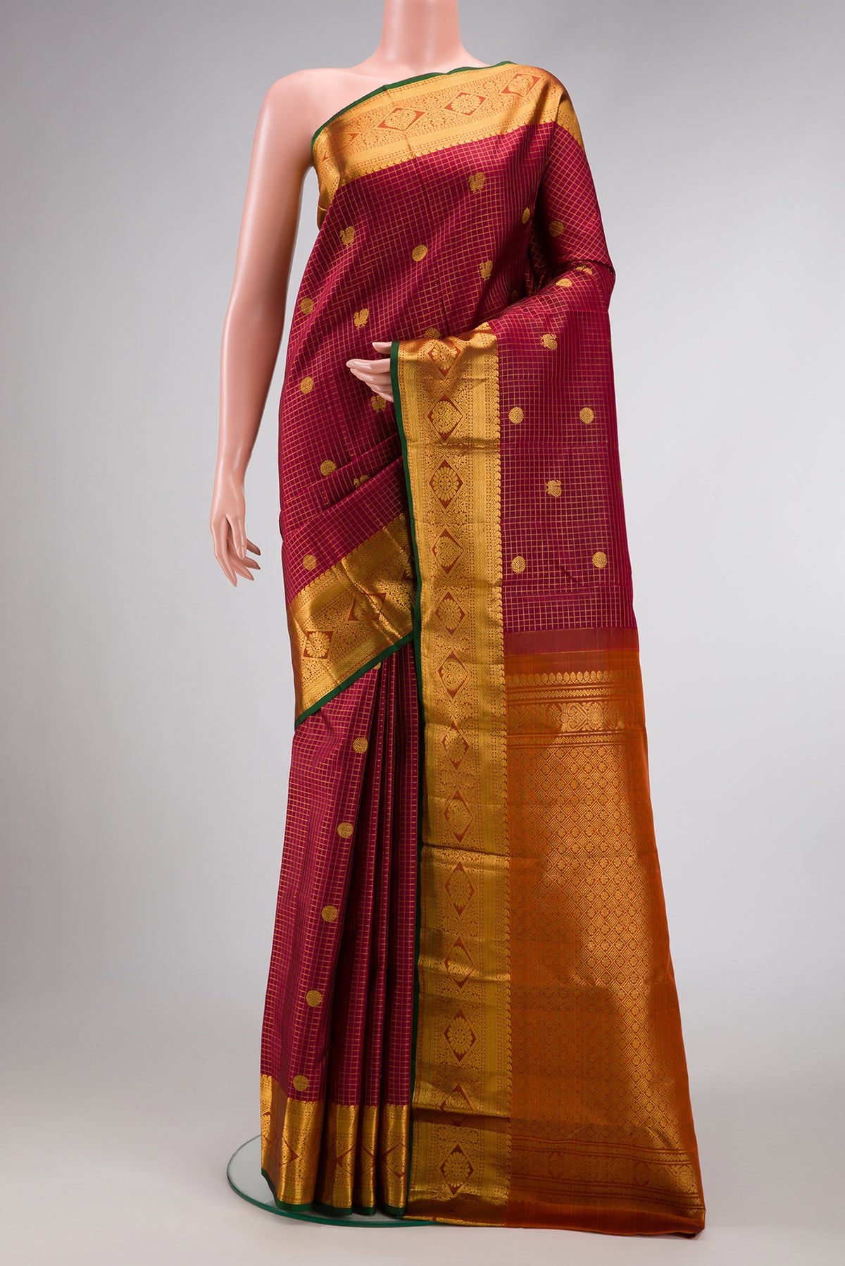 Maroon Dual Tone Kanjivaram Silk Saree with Checked design on the body and Zari Border.  displayed on a mannequin