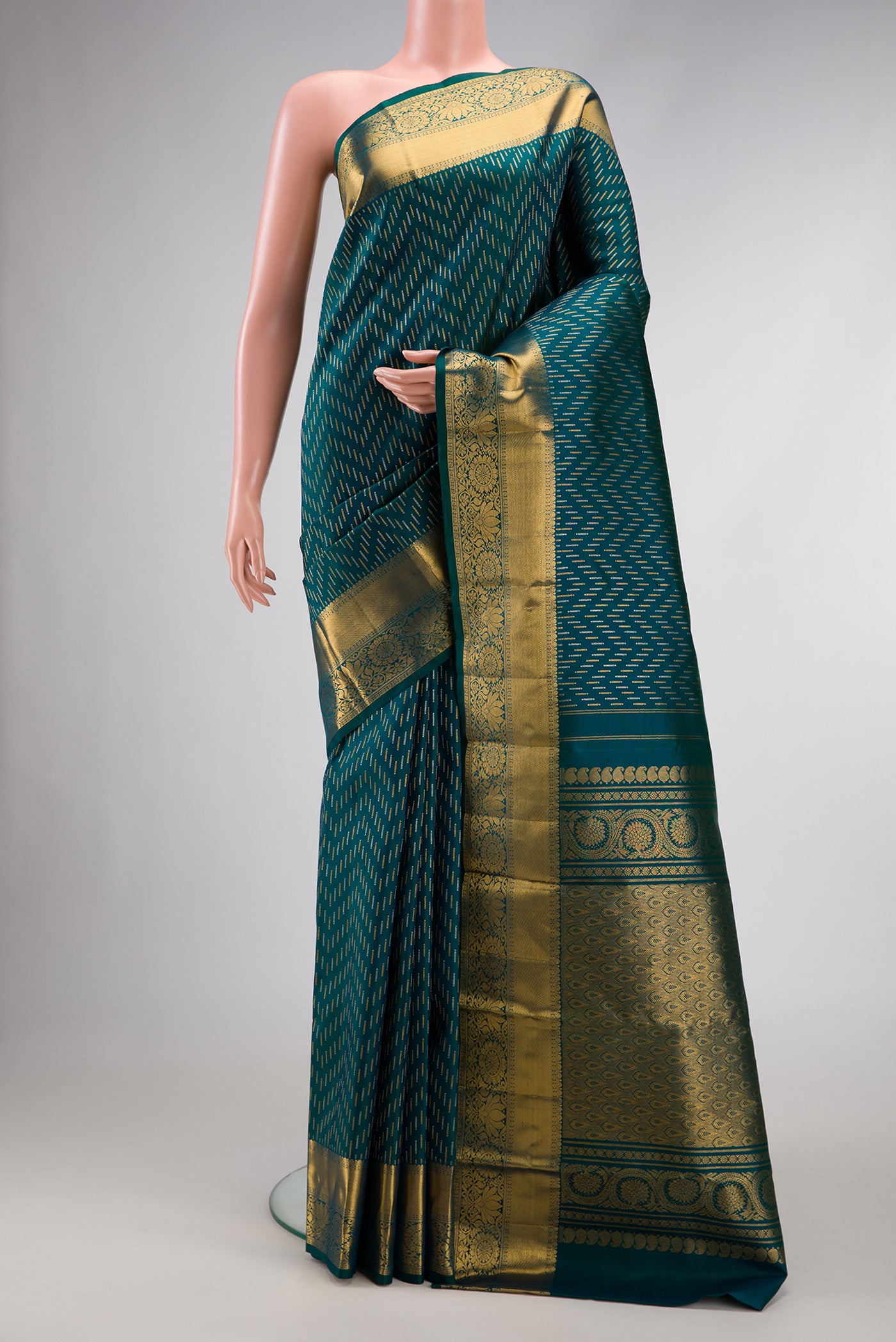 Green Dual Tone Kanjivaram Silk Saree with Zari Brocade on the body and Zari Border.  displayed on a mannequin
