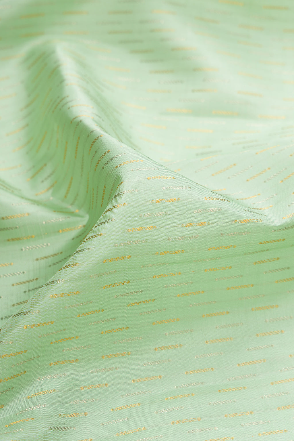 Close up of Pista Green Dual Tone Kanjivaram Silk Saree with Zari Brocade on the body and Zari Border.  displaying folds