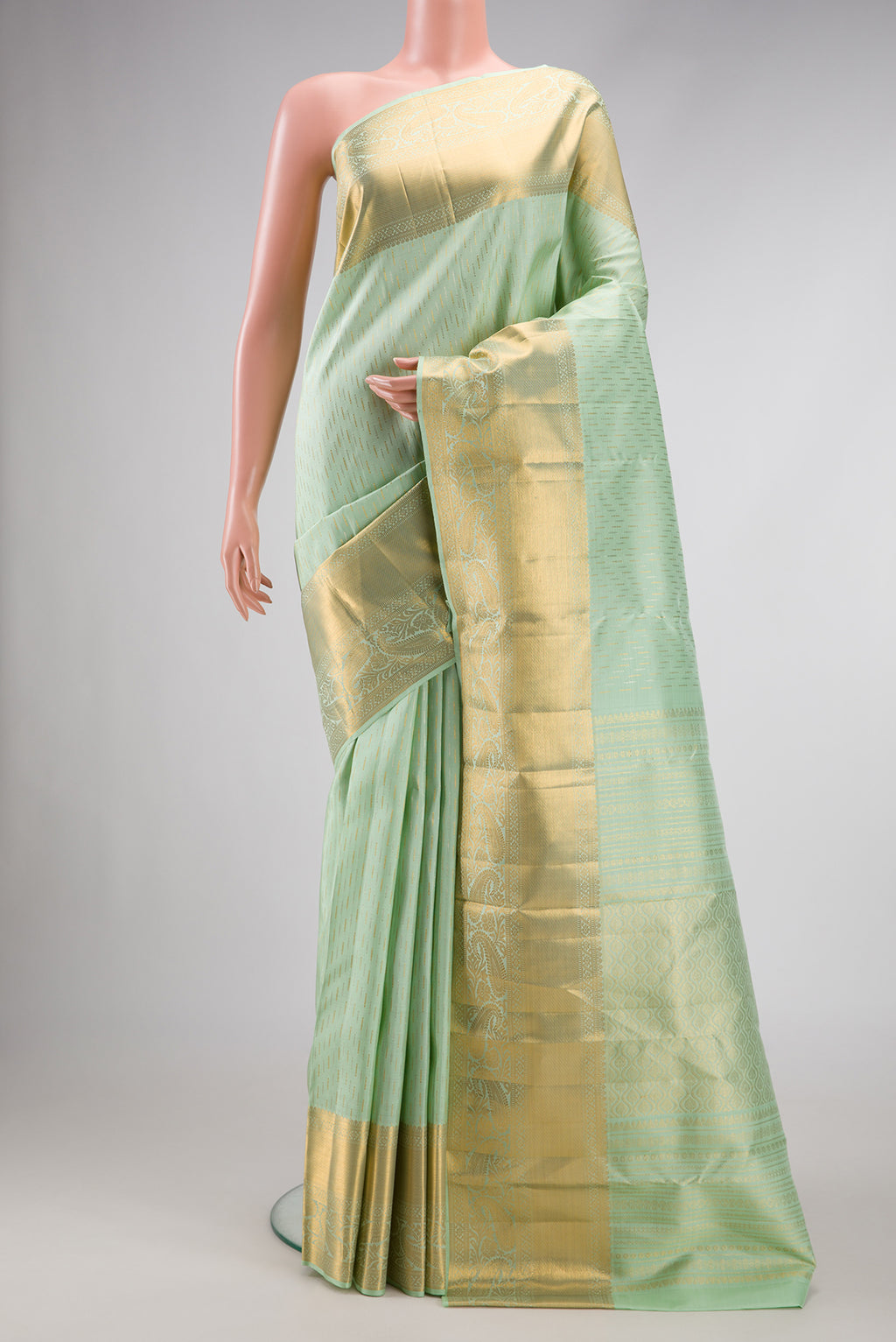 Pista Green Dual Tone Kanjivaram Silk Saree with Zari Brocade on the body and Zari Border.  displayed on a mannequin