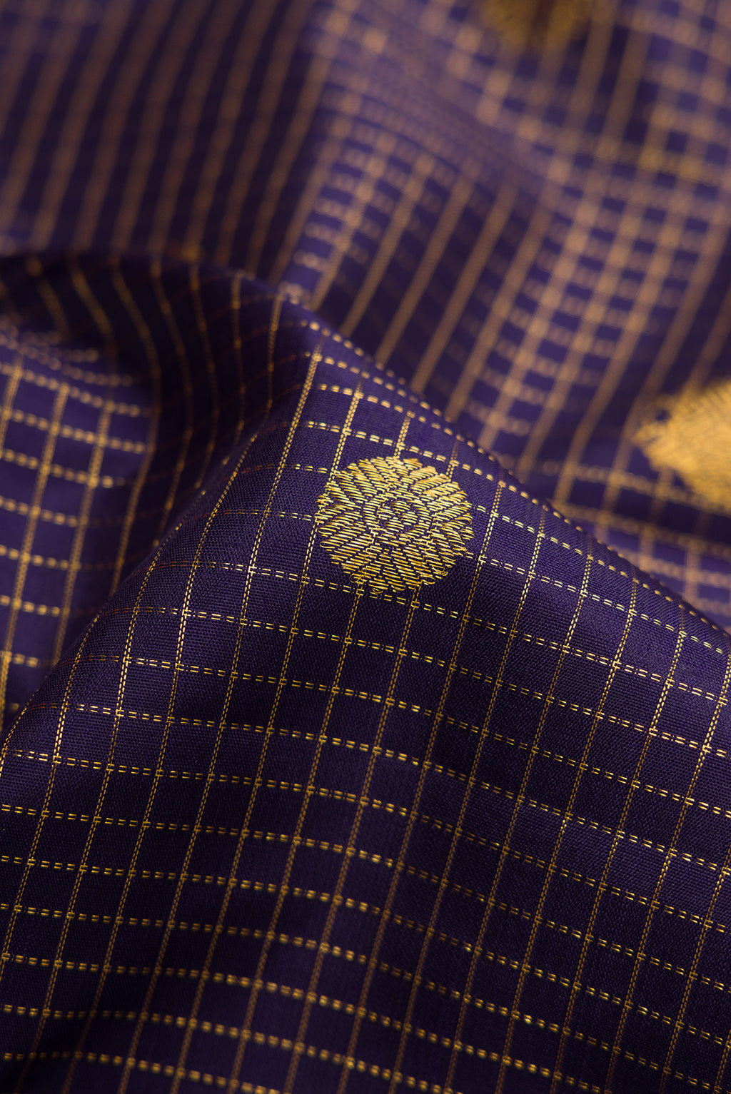 Close up of Navy Blue Dual Tone Kanjivaram Silk Saree with Checked design on the body and Zari Border.  displaying folds