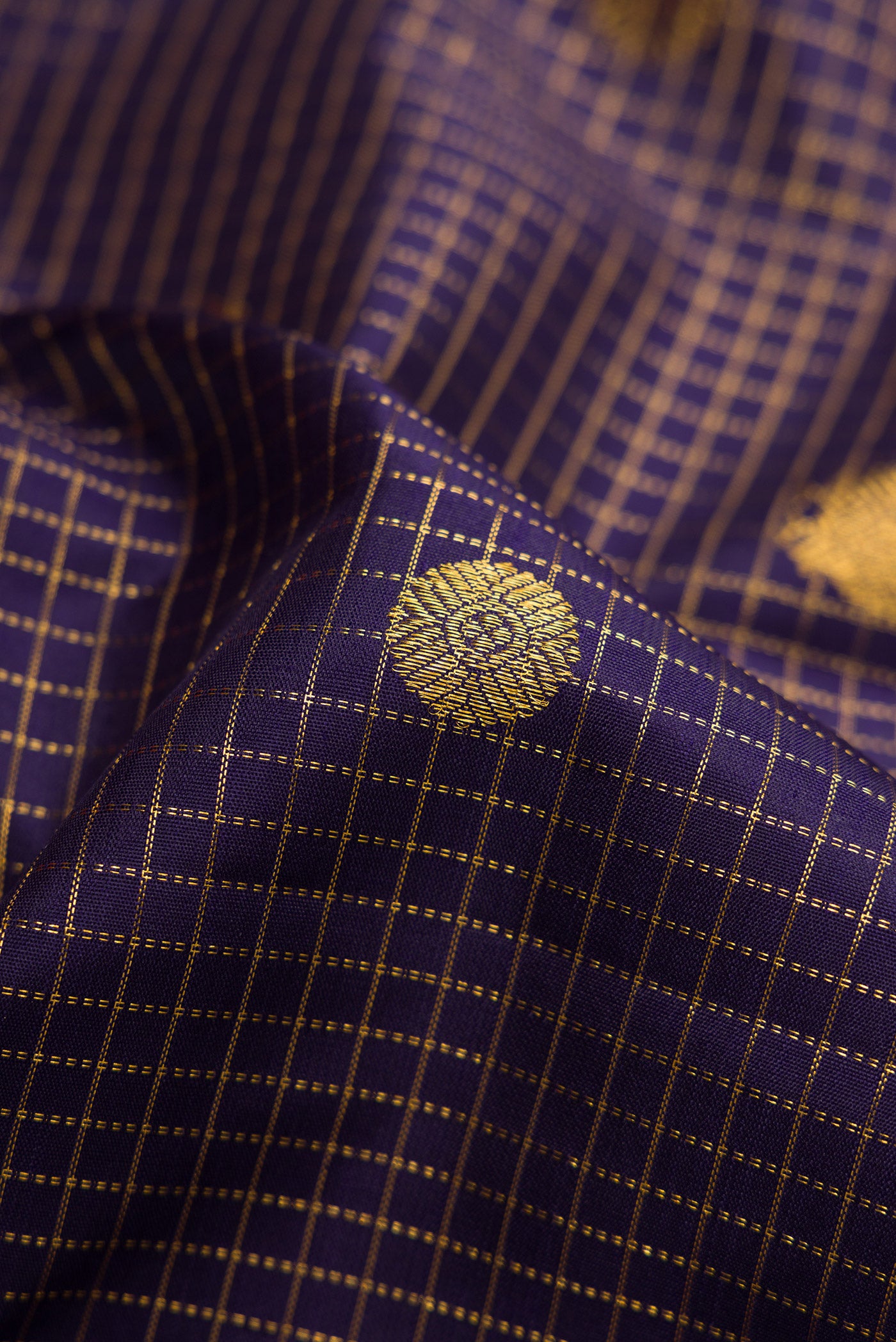 Close up of Navy Blue Dual Tone Kanjivaram Silk Saree with Checked design on the body and Zari Border.  displaying folds