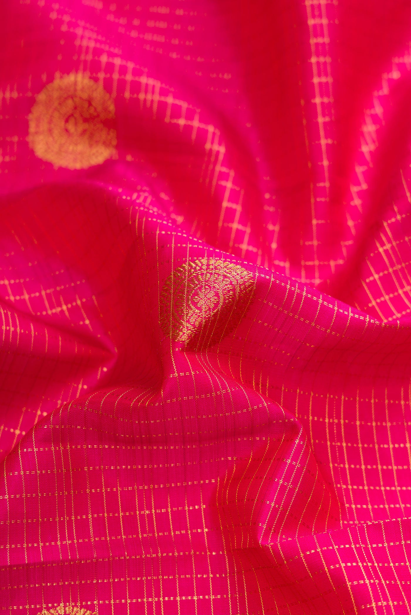 Close up of Pink Dual Tone Kanjivaram Silk Saree with Checked design on the body and Fancy Border.  displaying folds