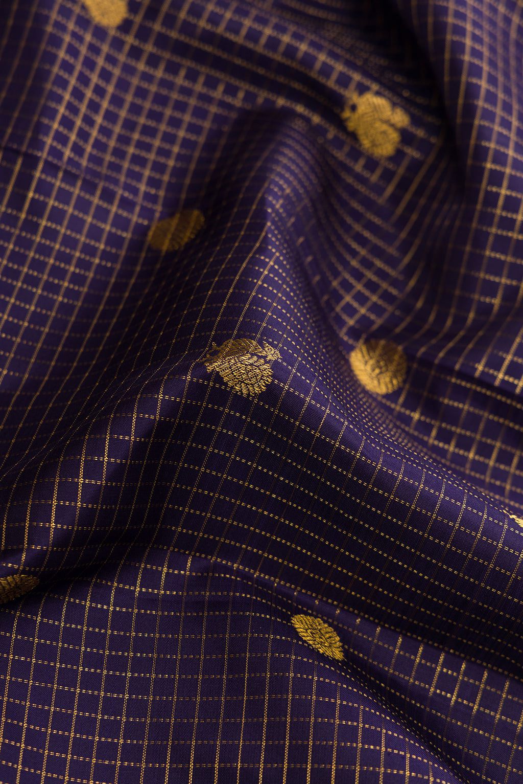 Close up of Navy Blue Dual Tone Kanjivaram Silk Saree with Checked design on the body and Zari Border.  displaying folds