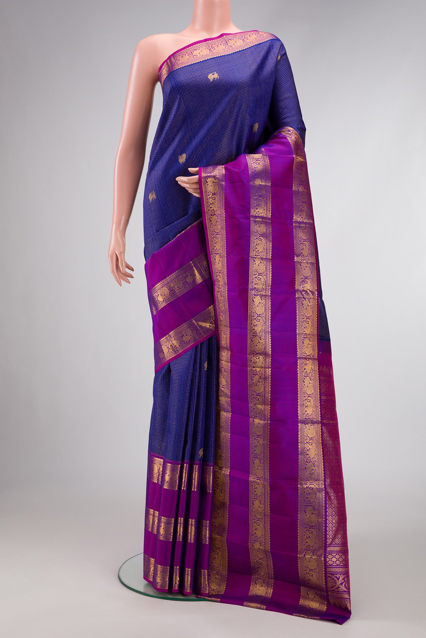 Navy Blue Dual Tone Kanjivaram Silk Saree with Checked design on the body and Zari Border.  displayed on a mannequin